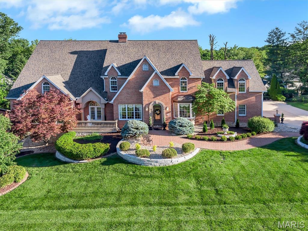 Experience luxury living at its finest in this stunning home located in the highly sought-after Sunset Hills neighborhood of Edwardsville. Beautifully maintained and in premium condition, this exceptional property offers elegant design, high-end finishes, and resort-style outdoor living complete with a sparkling pool, lush landscaping, and private sports court. Spacious living areas are filled with natural light and designed for both everyday comfort and entertaining. The impressive main-floor primary suite features a spa-like ensuite bath and expansive dual closets, while the upstairs private den creates the perfect space for movie nights or entertaining guests. The finished walkout basement has the feel of another home in and of itself. It includes a large office, sitting area overlooking the backyard oasis, entire full kitchen, wine fridge, and many more unique custom features. Step outside to a beautifully designed outdoor living space ideal for hosting gatherings, relaxing poolside, or enjoying peaceful evenings surrounded by mature landscaping. A rare opportunity to own a truly remarkable home in one of Edwardsville’s premier communities.