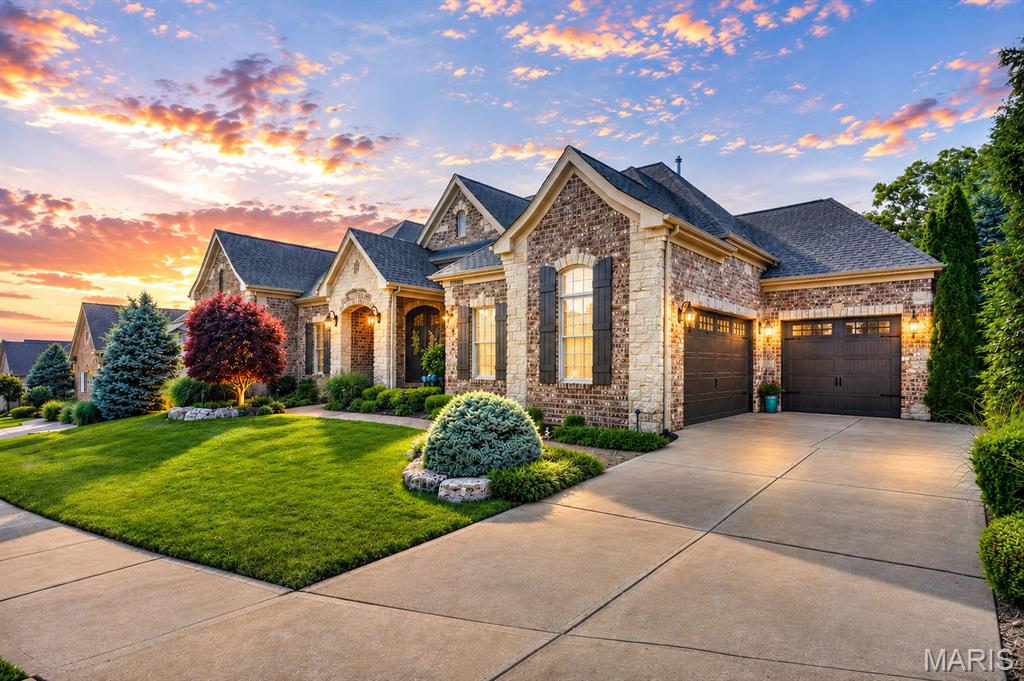 Stunning stone and brick ranch offering over 5,300 sf of total living space including 2,800 sf on the main level, thoughtfully designed with luxury finishes and exceptional craftsmanship throughout. Soaring 10' and 12' ceilings, including coffered and box ceiling details, create an elegant and spacious feel from the moment you enter the steel and glass front doors. 
The main level features 2 bedrooms plus a private office with beautiful built-in desks and custom furniture that could easily serve as a fourth bedroom with slight modifications. Entertain in style with a separate formal dining room and a chef's dream kitchen complete with stainless steel and built in cabinet appliances, instant hot water, reverse osmosis water softener, natural gas 5 burner cooktop, massive 10'x5' center island, breakfast room and inviting hearth room with floor to ceiling stone gas fireplace.
The finished lower level expands the living space with a 3rd bedroom, full bath, and a versatile room with mirrored walls and French doors ideal for a fitness room, studio, or additional flex space. Ample unfinished basement area provides exceptional storage opportunities.
Step outside to enjoy the covered aggregate patio with overhead heaters and charming courtyard area surrounded by professionally landscaped grounds offering incredible privacy in the backyard. The 3-car insulated and split garage adds convenience and curb appeal.
A community pool adds to the amenities without the homeowner hassle. Ideally located near shopping, restaurants, and everyday conveniences. All within the Rockwood school district.
