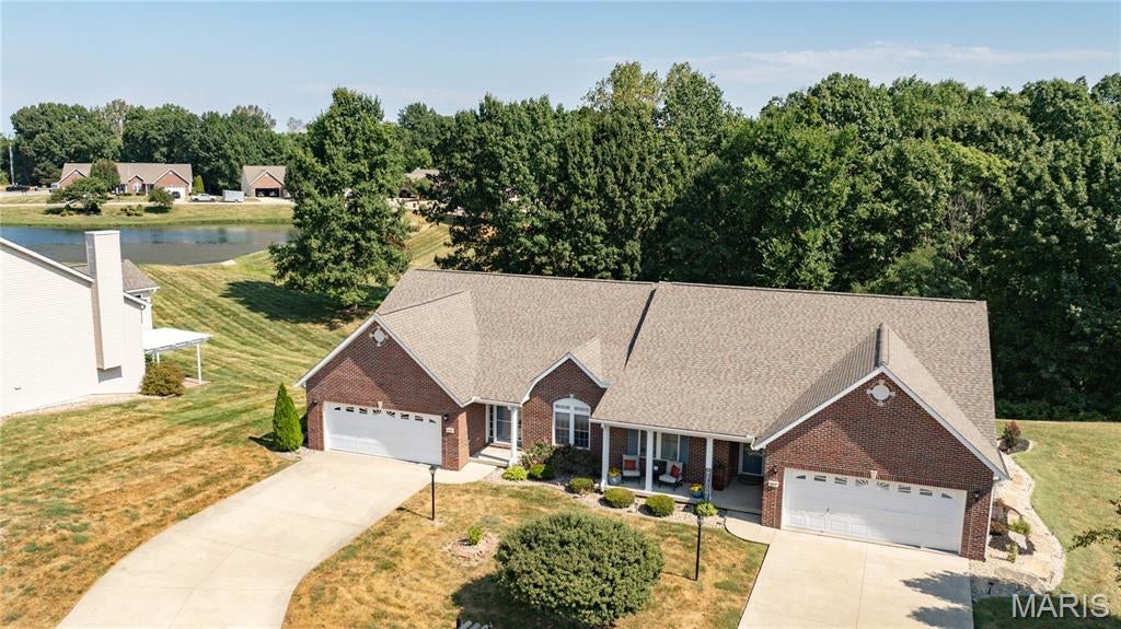 Nestled near the end of a quiet cul-de-sac in the desirable Davis Pond Subdivision, this inviting home offers peaceful nature views while remaining close to everyday amenities. The spacious, open floor plan features a vaulted ceiling and cozy fireplace in the great room, along with a dining area and well-appointed kitchen with an island & pantry that flows into the bright, inviting sunroom—perfect for morning coffee, relaxing, or enjoying the changing seasons year-round. The main level includes a primary suite with a private bath featuring a soaking tub, separate shower, and walk-in closet, along with a second bedroom, full bath, convenient main-level laundry room, and two-car attached garage. The unfinished walkout lower level offers excellent potential for additional living space and storage. Enjoy the ease of low-maintenance living, giving you more time to relax & entertain.