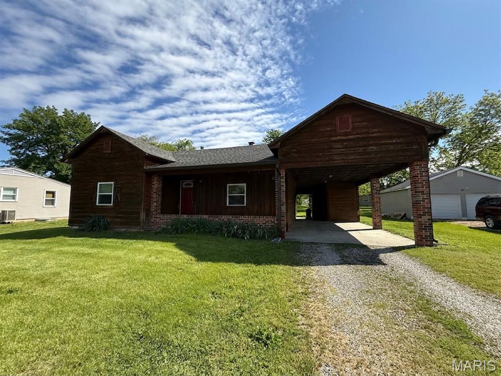 Charming 2 bedroom, 1 bath cedar-sided home with a partially finished basement and so much to offer! Enjoy relaxing on the nice covered front porch or entertaining in the spacious great room featuring a cozy wood-burning fireplace.
This home offers updated bathroom finishes, updated kitchen countertops, and newer flooring throughout most of the home. Large attached carport with additional storage shed area inside the carport for extra convenience.
Level backyard with plenty of space to enjoy outdoors. Great combination of comfort, updates, and character!
