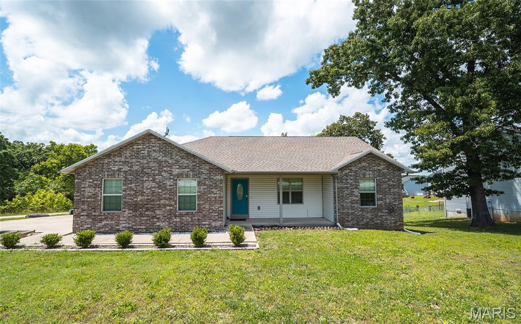 Welcome home to this beautifully maintained 3-bedroom, 2-bath residence in the heart of St. Robert, offering the perfect combination of comfort, convenience, and modern style. Located just minutes from Fort Leonard Wood, shopping, dining, and everyday amenities, this home is ideal for anyone looking for easy living in a highly desirable location. Step inside and immediately appreciate the bright, open floorplan designed to make everyday life feel effortless. Vaulted ceilings create an airy, welcoming atmosphere while the laminate flooring throughout the home adds warmth, durability, and a clean modern touch. The spacious living area flows seamlessly into the kitchen, where stainless steel appliances and ample cabinet space make cooking and entertaining a breeze. The primary suite offers a relaxing retreat at the end of the day, complete with a spacious layout, dual sinks, and a walk-in shower designed for both comfort and functionality. Two additional bedrooms provide flexibility for guests, family, or a home office setup. Outside, enjoy peaceful mornings or evening conversations from the covered front porch while taking in the charm of the neighborhood. With its well-maintained condition, functional layout, and unbeatable location, this home is truly move-in ready. Schedule your private showing today and see everything this St. Robert gem has to offer!