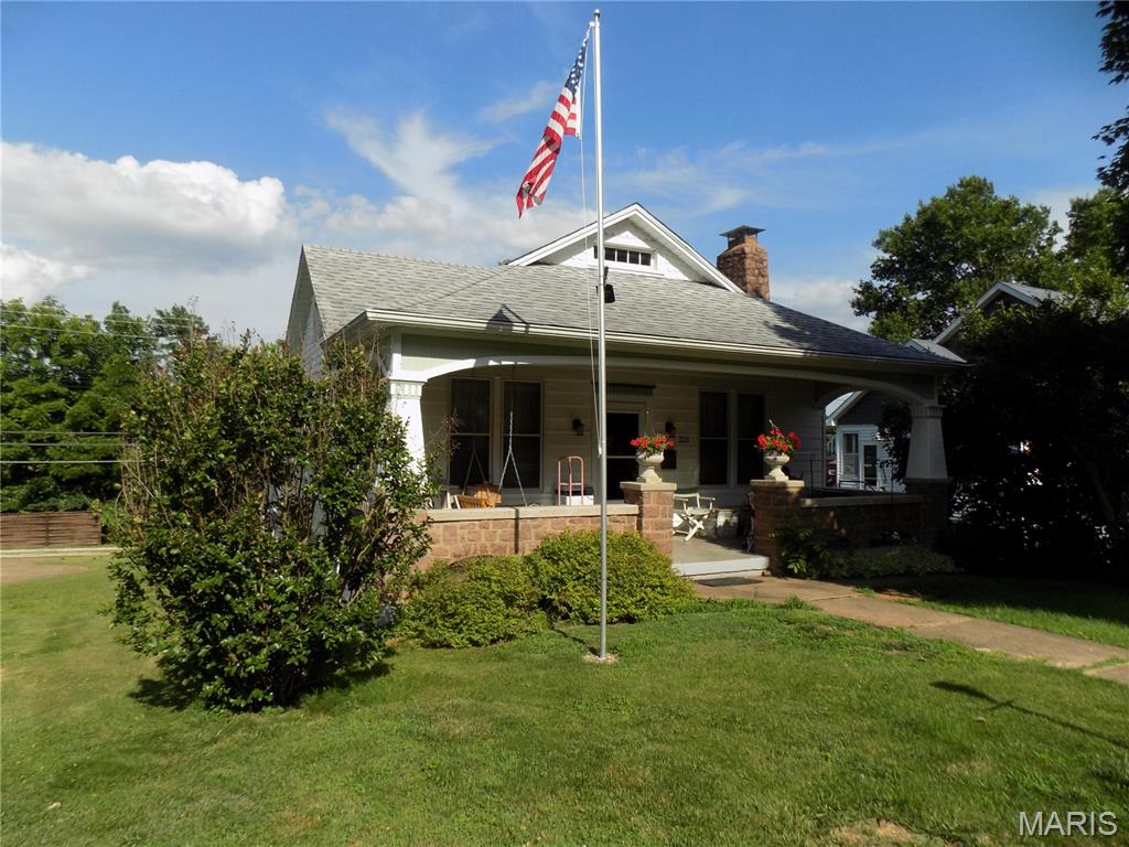 Well built and maintained older, charming bungalow, with living room, with granite fireplace for those winter evenings, dining room, kitchen with range, refrigerator, dishwasher, sunroom off kitchen, has large attic unfinished but could be converted to living area, beautiful natural woodwork, full basement with garage and access from alley, central air and central heat, newer roof, and a large covered front porch for those relaxing evenings.  A very comfortable home!