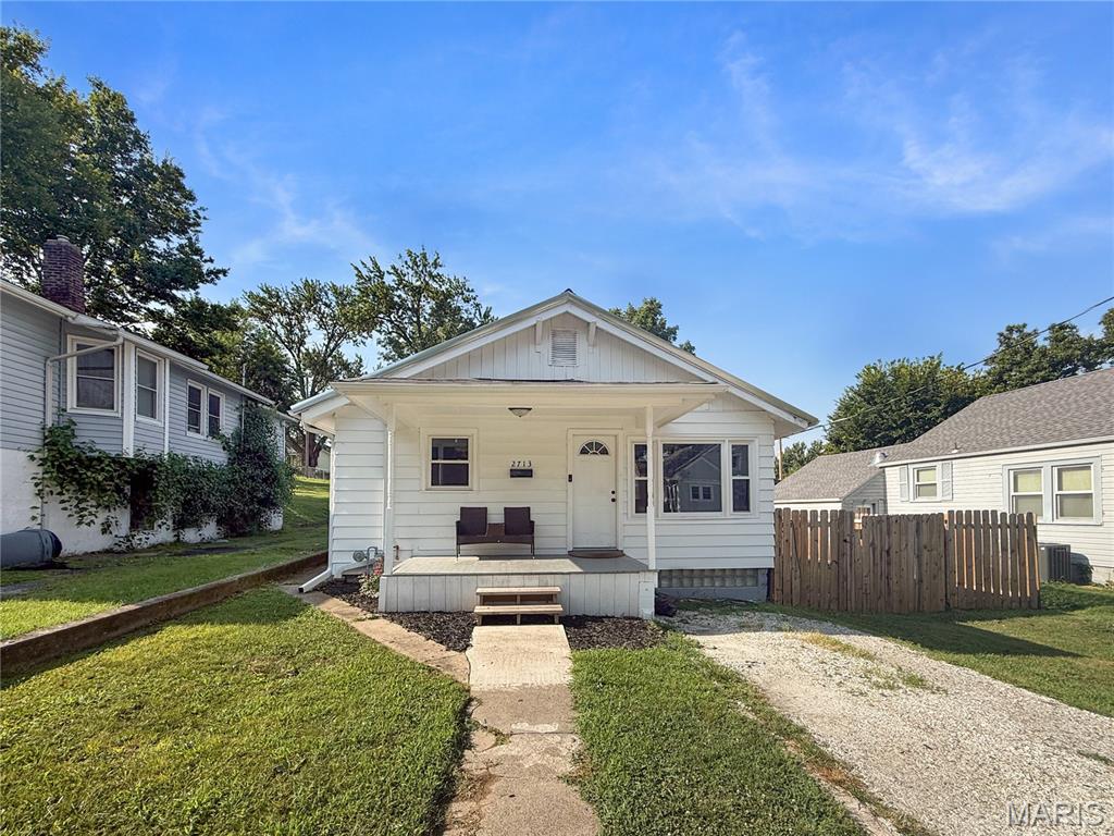Move-in ready and full of updates, this charming 2-bedroom, 1-bath bungalow offers the perfect blend of character and modern convenience. Original hardwood floors, abundant natural light, and an open, inviting feel welcome you inside. The beautifully updated kitchen features custom cabinetry, stainless steel appliances, and a bright dining area that opens to the covered back porch—perfect for relaxing or entertaining. The remodeled bathroom showcases custom tile, a double vanity, and updated fixtures. Major improvements include updated windows and doors, a forced-air furnace and central air, updated plumbing and electrical, and a durable metal roof. Outside, enjoy the newly fenced backyard, providing a great space for pets, play, or outdoor gatherings. The oversized 2-car garage offers ample parking, workshop space, and alley access, while the full basement provides additional storage. Conveniently located near Mark Twain Elementary, this well-maintained home is ready for its next owners.