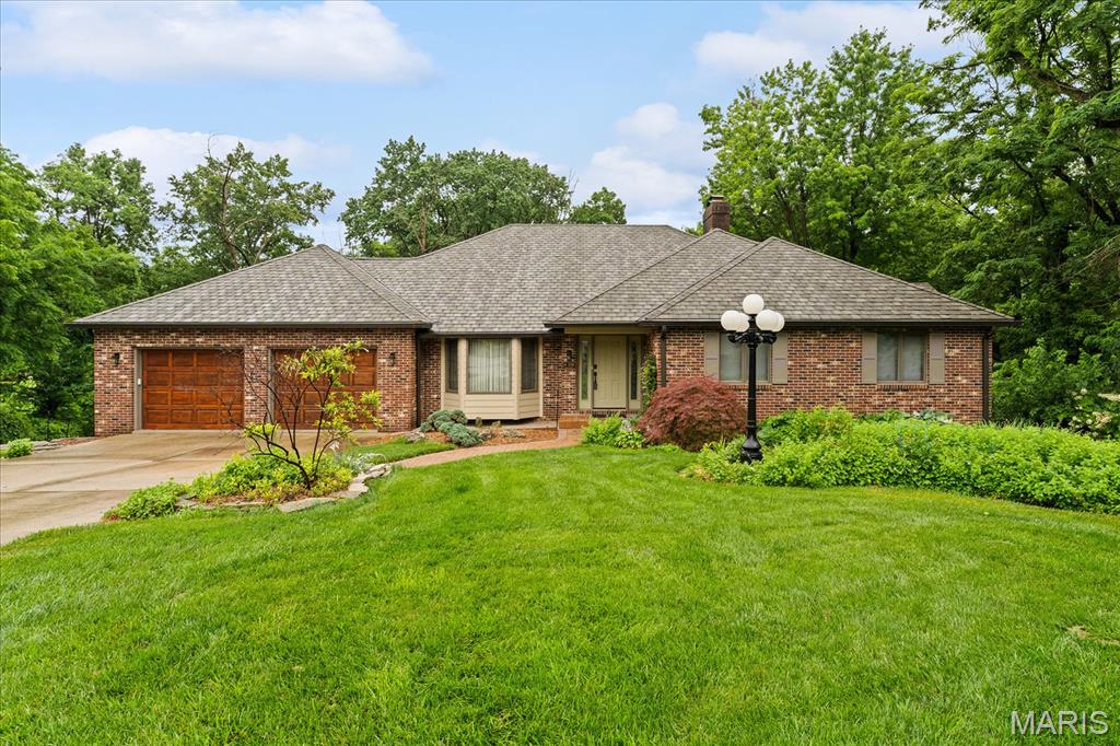 Beautiful ranch on Timberlake with walkout basement and stunning lake views. Wooded path leads to private lakeside firepit. Adjoining lot adds privacy and wildlife. Main level features vaulted living room with gas fireplace, island kitchen with breakfast area and screened porch, plus two bedrooms and full bath. Expansive primary suite includes sitting room, dressing area, luxury bath, gas fireplace, and large walk-in closet. Walkout lower level offers fireplace, wet bar, exercise room, full bath, and potential for two additional bedrooms, ideal for guest suite with private entrance and access to fenced yard and patio. Stone steps to lake, abundant storage, and special millwork throughout.