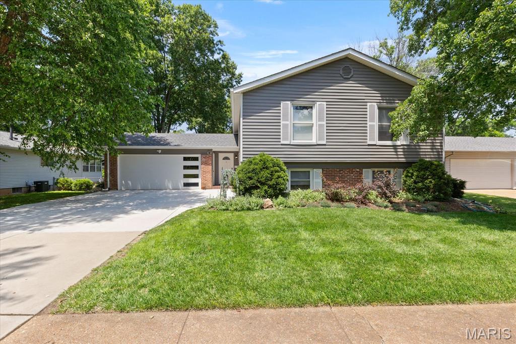Thoughtfully updated and move-in ready, this beautiful home is waiting for its new owners! Step inside to a welcoming foyer that provides access to both the main level and the finished lower level. The main floor features stylish luxury vinyl plank flooring, a spacious living room, and an open-concept layout that seamlessly connects the kitchen and dining areas. The updated kitchen showcases crisp white cabinetry, granite countertops, stainless steel appliances, a pantry, and a center island with seating—perfect for everyday living and entertaining.

The main-level primary suite offers a walk-in closet and an updated private bath, while two additional bedrooms and a second updated full bath complete the floor. Downstairs, the finished walk-out lower level is designed for gathering and entertaining, featuring a comfortable family room, an expansive recreation room with a wet bar and wood-burning stove, a half bath, and direct access to the patio. An office plus unfinished utility and storage space provide added flexibility and convenience. Outside, enjoy a fenced backyard, new deck with Trex decking and , lower level patio, and attached 2-car garage. Additional peace of mind comes with a newer roof and gutters. Don't miss your opportunity to make this exceptional home yours—Welcome Home!
