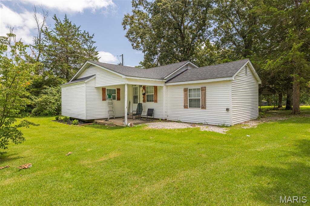 Escape to the peace and privacy of country living with this recently updated home, conveniently located on a blacktop road. Thoughtfully remodeled with major improvements already completed, this property features a new roof (2025), new septic system (2023), and a French drain installed around the home for added peace of mind. Inside, you'll find a spacious kitchen with new stainless steel appliances and a window overlooking the backyard, making it the perfect space for cooking while keeping an eye on kids, pets, or enjoying the view. The home also offers covered parking for two vehicles. Outside you'll find a welcoming covered front porch and an open back deck that leads to a fenced yard, perfect for children and pets to safely play. The detached shop building features concrete floors and electricity, making it perfect for a workshop, hobbies, or additional storage. Also included is covered RV parking pad. The mixture of cleared space, wooded areas and pond tucked away add to the property's country charm. Whether you're looking for room to spread out, space for your hobbies, or a peaceful setting to call home, this move-in ready property offers the perfect blend of modern updates and rural living!