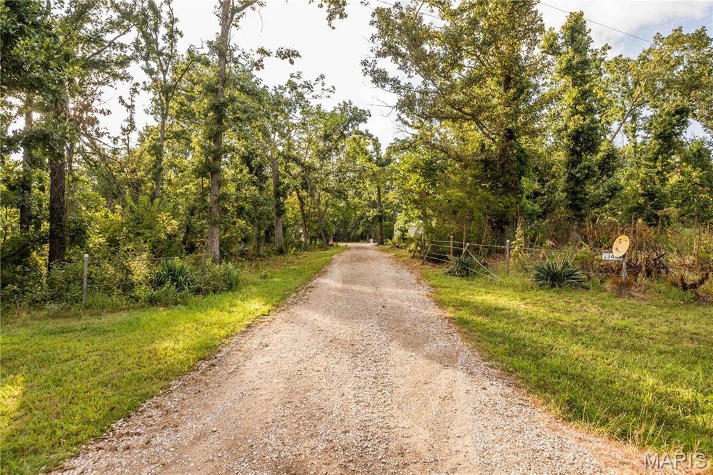Minutes from Truman Lake, this 10-acre property offers endless possibilities with two residential cabins, a large storage shed, and an additional equipment shed. Cabin 1 features 2 bedrooms, 1 full bath, an open living area, and a spacious 12x18 covered deck perfect for relaxing and enjoying the peaceful surroundings. Cabin 2 offers an open-concept layout with a full kitchen, full bathroom, and laundry hookup. There ia a 30amp camper hookup with water connection. Surrounded by mature trees and rolling terrain, the property provides plenty of room for recreational vehicles, equipment, storage, or future expansion. Don't miss your opportunity to make this place yours!
