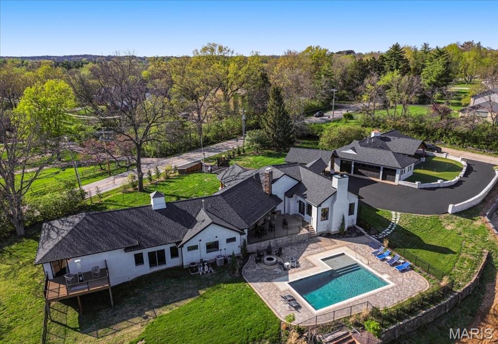 A rare opportunity to own a fully reimagined, resort-style estate offering true compound living in the heart of Town & Country—now positioned at a compelling value.

Welcome to 1824 Topping Road. Set on 1.4 acres with an elevated setting and long-range views, this nearly 7,200 square foot property blends modern design with warm architectural character, creating a home that lives as well as it shows.

The main residence is anchored by a vaulted great room with exposed beam detail and a custom stone fireplace, filled with natural light and seamlessly connected to the outdoor living areas. The kitchen is both functional and refined, featuring high-end appliances, a large island, custom cabinetry, and a fully built-out walk-in butler’s pantry. A formal dining area and an additional living room with its own fireplace and custom bar provide multiple spaces for gathering, entertaining, or everyday use.

The primary suite offers a private retreat with views toward the pool and grounds, complemented by a spa-like bath with soaking tub, oversized walk-in shower, and custom walk-in closet.

What truly sets this property apart is the flexibility of its additional living spaces—an increasingly rare feature at this level. The fully renovated guest house functions as a true extension of the home, complete with its own kitchen, living area, private bedroom suite, gym, and covered patio with a custom putting green. A separate recreation space with an upper-level suite provides yet another option for guests, work-from-home separation, or long-term living arrangements.

The outdoor setting is designed for both relaxation and entertaining. A resort-style pool and expansive deck serve as the centerpiece, complemented by a firepit, multiple seating areas, and thoughtful landscaping. The main living areas and pool are positioned to capture the best of the property’s setting, creating a natural backdrop without sacrificing privacy.

Extensively renovated with architectural oversight and quality craftsmanship throughout, this property offers the feel of a custom home—without the timeline or uncertainty of building. For buyers seeking space, flexibility, and a property that delivers a true lifestyle experience, 1824 Topping presents a unique opportunity at its current offering.