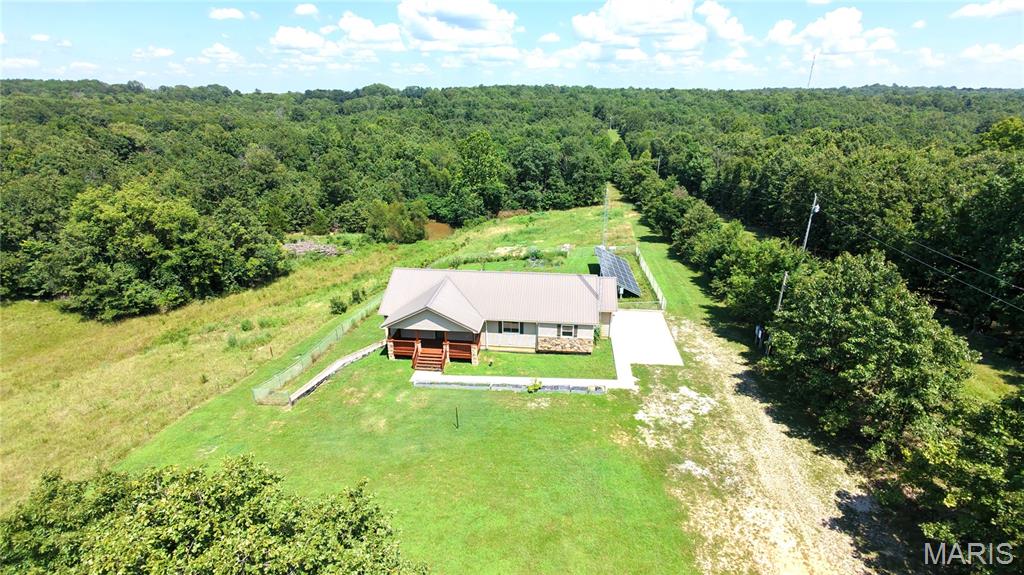 For Sale - 404 County Road 309, Alton, MO 65606.

Escape to the beauty of the Missouri Ozarks with this spacious 5-bedroom, 3-bathroom ranch home on 11.5 private acres in scenic Oregon County. Built in 2015, this home offers an open-concept floor plan with over 3,000 square feet of living space, beautiful panoramic views, and the perfect blend of comfort, privacy, and outdoor recreation.

The main level features a bright living, dining, and kitchen area with a center island, stainless steel appliances, pantry, and access to the rear deck. The primary suite includes a double vanity, walk-in shower, and soaking tub. Two additional bedrooms and a full bath complete the main floor.

The finished walkout lower-level offers a large family room, two additional bedrooms, a full bath, and new carpet and luxury vinyl flooring installed in 2026.

No electric bill with the owned Tesla 10.125 kW solar array with two Powerwall 3 battery backup systems. New septic system installed in 2026. Additional features include a metal roof, an attached two-car garage, central heat and air, high-speed internet availability, a fenced backyard, a gardening area, wooded acreage, and open fields.

Located just minutes from the Eleven Point National Scenic River, this property is an outdoor enthusiast's dream with outstanding opportunities for floating, fishing, hiking, hunting, and exploring the Ozarks.
Duplicate Listing # 26047159 (Farm)