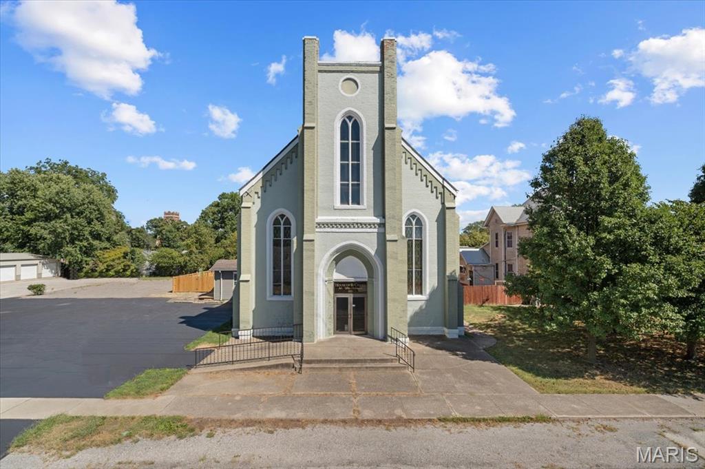TRULY ONE-OF-A-KIND! Step inside this beautifully restored former church, thoughtfully transformed into an extraordinary single-family residence where historic character meets sophisticated modern living. Soaring ceilings, original stained-glass windows, stunning terrazzo floors, and striking architectural details create a dramatic backdrop unlike anything else in the area. The expansive, open-concept living spaces are designed for entertaining, gathering, or simply enjoying the remarkable scale and character of the home. A full kitchen and versatile floor plan offer exceptional flexibility for everyday living, creative pursuits, or a live/work concept. Located in the heart of Carlinville, this remarkable property offers the rare opportunity to own a true piece of local history—reimagined for today with incredible space, character, and possibilities for the future.