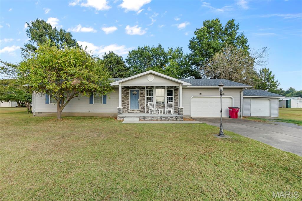 Very motivated seller !!!!!  Just outside of Sikeston, this 3-bedroom, 2-bathroom home sits on a spacious half-acre lot and includes the adjoining half-acre vacant lot, giving you a full acre to enjoy. Relax on the front porch and take in breathtaking, unobstructed sunsets, or cozy up in the inviting family room/den with its warm gas fireplace. The property also features two additional outbuildings, perfect for storage, hobbies, or a workshop. With plenty of space both inside and out, this home offers comfort, charm, and room to grow all in a peaceful setting just minutes from town.
