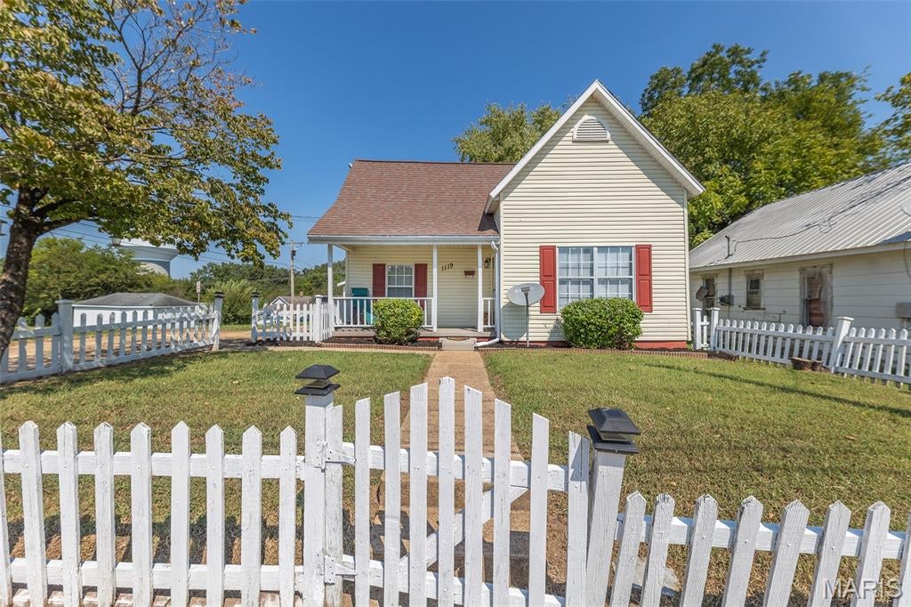 This charming traditional home, complete with a classic white picket fence, feels like it was plucked straight from a storybook! Situated on a desirable corner lot, it offers beautiful curb appeal along with everyday convenience, including off-street parking and a small garage perfect for storage. Inside, you’ll find a semi-open floor plan filled with natural light and inviting spaces. The spacious kitchen features ceiling-height cabinetry for ample storage, included appliances, and a convenient pet door for your four-legged friends. A separate dining room provides plenty of space for everyday meals or hosting guests. The main level offers two bedrooms, including one with a large walk-in closet, along with a remodeled full bathroom. Upstairs, the flexible additional space is ready to suit your needs! Use it as a third bedroom, home office, playroom, creative space, or whatever fits your lifestyle. French doors from the kitchen lead to your private backyard oasis, where you can relax or entertain on the low-maintenance composite deck. A new wood privacy fence and a perimeter of dappled shade trees create a peaceful setting while still being right in the heart of the city.
With a brand-new roof adding peace of mind for years to come, this delightful home pairs timeless charm with practicality. Don't miss the chance to make it yours!