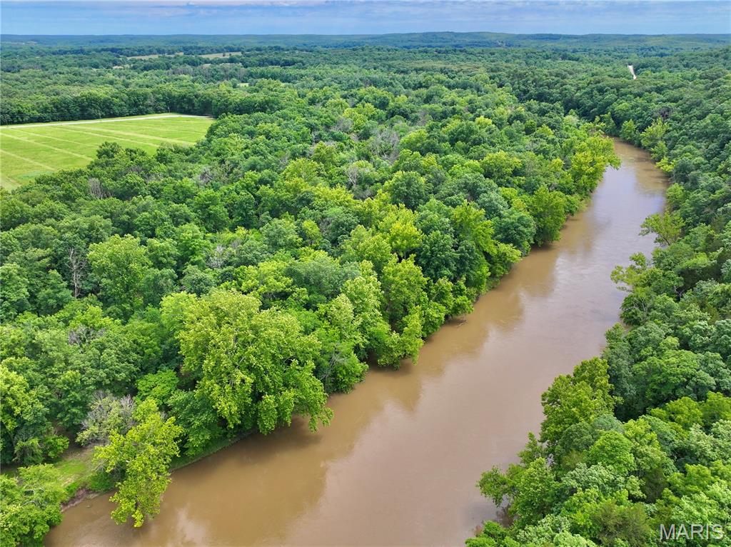 Discover the perfect blend of privacy, convenience, and riverfront recreation on this 7.56-acre tract featuring 277+ feet of private Sac River frontage. In addition to your direct river access, this property also includes a secondary deeded river access point just upstream, providing even more opportunities to enjoy the water.

Located less than 2 miles from Highway 54 at the end of a dead-end county road, the property is accessed through a private road secured by an electric gate, offering both convenience and peace of mind. The land features an attractive mix of open ground and mature timber, creating an ideal setting for a future home, cabin, or recreational retreat.

Buildable acreage outside the floodplain provides excellent development potential, while electric has already been run to the property, saving time and expense. Along the riverbank, towering mature trees create a beautiful shaded canopy with an open, park-like woodland beneath, making it easy to enjoy the property’s natural beauty.

Whether you’re looking for a weekend getaway, future homesite, or private riverfront escape, this property delivers. Enjoy beautiful 360-degree views, direct access to the Sac River, abundant wildlife, and a peaceful setting that feels secluded while remaining easily accessible. Properties offering private river frontage, gated access, utilities, and buildable acreage this close to Highway 54 are increasingly difficult to find. Additional acreage may be available upon request.