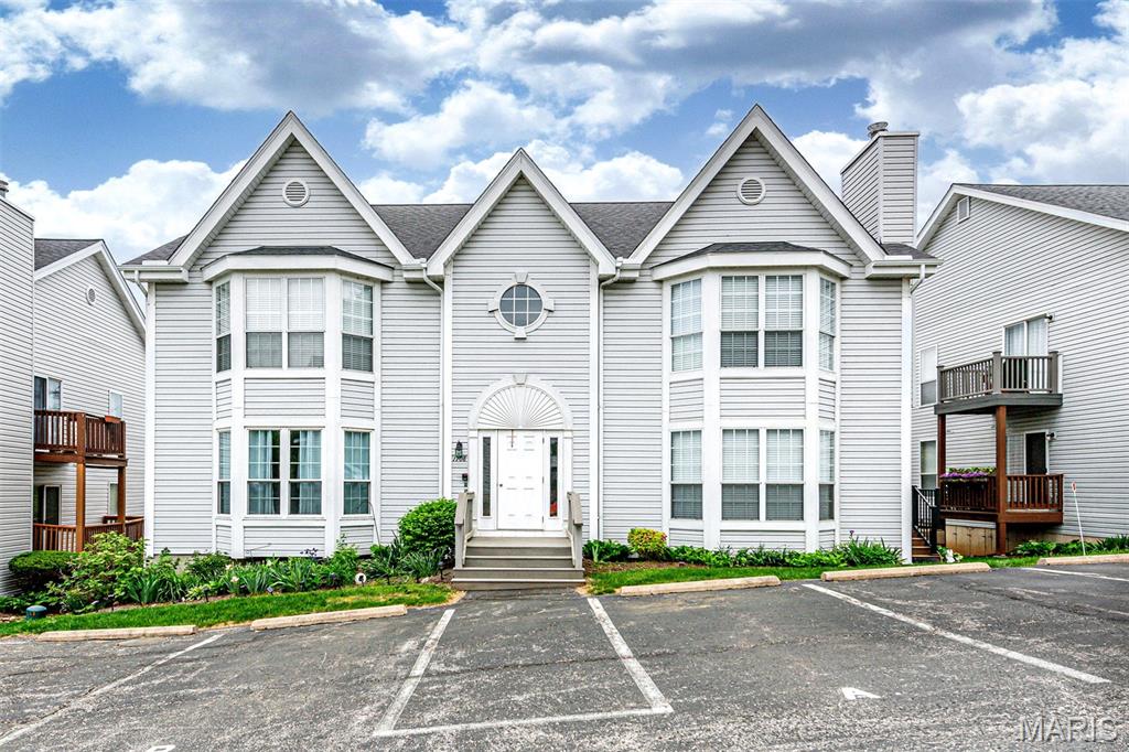 Welcome to easy, low-maintenance and low noise living in the heart of Ballwin! This ground-floor (easy access ) condominium features 2 bedrooms, 2 full baths, and an open floor plan with hardwood flooring throughout the main living areas. Large bay windows fill the home with natural light, creating a warm and inviting atmosphere. The updated kitchen offers LG stainless steel appliances (Included & stay) and overlooks the living space, making it perfect for entertaining. Both bathrooms have been tastefully updated with designer tile and modern fixtures. Enjoy fresh air and outdoor relaxation on the spacious 21' x 5' private composite deck ,(very few units has  deck of this size) Additional 10’x10’ storage and one-car garage in the lower level (other than assigned parking right at front) plus plenty of guests parking . The HOA covers exterior maintenance, allowing more time to enjoy life, whether traveling, pursuing hobbies, or simply relaxing at home. Community amenities include a pool, grounds maintenance, and insurance. Schedule your private tour today!