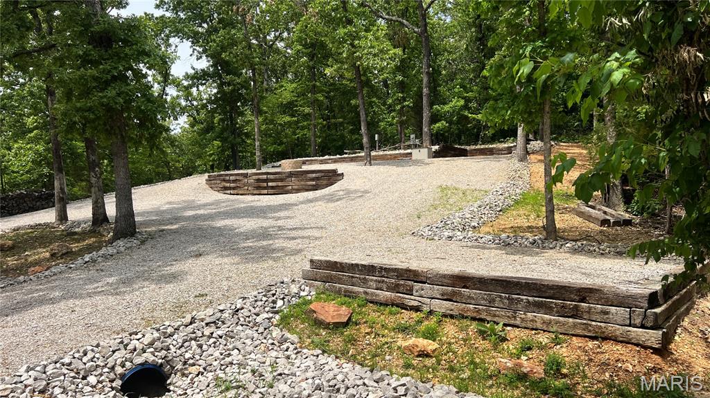 MOTIVATED SELLER! MAKE OFFER! Who’s ready to make unforgettable memories this summer? 
I've got the perfect getaway waiting for you!  Located inside the gated Lake Perry Community, this beautiful spot at Lot 1036 Erie Trail Drive (0.73 ac) offers stunning lake views. This fully set-up, camp with permit lot makes it easy to enjoy lake life from day one.  Whether you are out on the lake relaxing in the water or back at the lot soaking in the peaceful surroundings at your fire pit, this is the ideal place to unwind.  Enjoy breathtaking sunrises and sunsets right from your lot, making every moment feel like a vacation. There is space available for a shed or pavilion with electric ran to either one on top of the hill and electric ran also for boat cover.  The camper electric service hook up is 50 amp. and there is access to hook onto Lake Perry sewer system if you would choose. As part of the Lake Perry Community, you'll also have access to amazing amenities including:  swimming pool, recreation center, laundromat & showers, sandy beaches, pavilions, and playgrounds.  All amenities are within a secure, gated community designed for comfort and fun.  Don't miss your chance to own the perfect summer escape.  Reach out today to schedule a viewing and start making lifelong memories at your new favorite spot!