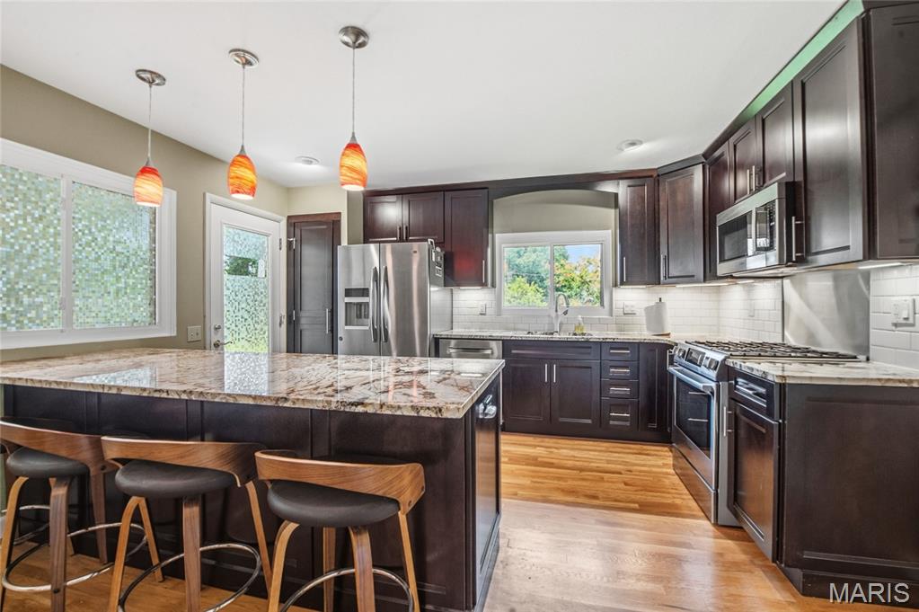 JUNE 7, 2026 OPEN HOUSE CANCELED. Move-In Ready & Absolutely Stunning! This beautifully updated 3-bedroom, 2-bath home effortlessly blends timeless charm with today’s modern finishes. From the moment you step inside, you’ll be captivated by the gorgeous newly refinished hardwood floors, abundant natural light, and inviting open-concept design perfect for both everyday living and entertaining.

The designer-inspired kitchen is truly the heart of the home, featuring gleaming granite countertops, stylish new cabinetry, stainless steel appliances, and an ideal flow into the dining and living spaces. The spacious primary suite offers a peaceful retreat complete with double closets and a beautifully renovated ensuite bath.

Entertaining is effortless both inside and out. Step through the kitchen onto the covered patio overlooking your own private backyard oasis—professionally landscaped with a tranquil waterfall and koi pond that creates the perfect setting for relaxing mornings or evening gatherings. Just off the kitchen, the warm and welcoming family room features custom built-in shelving and a cozy wood-burning fireplace.

Be sure to take in the stunning pond and waterfall feature in the backyard oasis, where the soothing sound of cascading water creates the perfect place to relax and unwind. Installed just over five years ago, this beautiful water feature has been designed to be virtually maintenance-free — simply enjoy the peaceful setting and feed the gorgeous koi. And for koi enthusiasts, or those looking to learn more, St. Louis even has a local Koi Club that is always welcoming new members!

The walkout lower level adds even more living space with a large recreation room, workshop area, laundry space, and abundant storage options. Major updates, including newer windows, interior and exterior doors, gutter guards, and HVAC (2023), provide added comfort and peace of mind. If buyers would like the refrigerator, washer & dryer are available to keep with the home. 

Located in the highly sought-after Parkway School District, this exceptional home offers the perfect combination of elegance, comfort, and functionality. Move in, unpack, and start enjoying everything this incredible home has to offer!
OPEN HOUSES Friday May 29, 2026 5pm to 7pm, Saturday May 30, 2026 1pm to 3pm, Sunday May 31, 2026 1pm to 3pm.

I have attached a link for the drone images and a 3D dollhouse image.