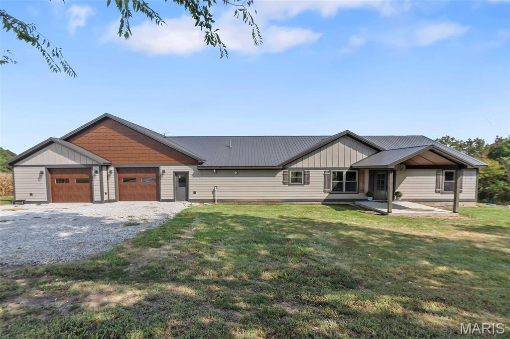 A rare opportunity to enjoy country living with an impressive collection of improvements
on 25 beautiful acres! This incredibly unique property combines a spacious remodeled
home, separate guest cabin, shop, barn, and a diverse mix of cropland, pasture, and
woods—all in a wonderfully private setting. Built in 2015 and completely remodeled in
2020, the main residence offers 2,208 square feet, 3 bedrooms, and 2 full baths with
a desirable split-bedroom floor plan. Step through the front door into a beautiful foyer
that opens to an expansive great room where the living, kitchen, and dining areas flow
together beneath a gorgeous tongue-and-groove vaulted ceiling. The spacious kitchen
offers abundant cabinetry, quartz countertops, a center island, included appliances, and
a generous corner pantry, with an adjacent dining area providing plenty of room for
gathering. An electric fireplace creates a cozy focal point in the living room, while
expansive backyard views offer the opportunity to watch wildlife right from the comfort of
home. The oversized primary suite provides a peaceful retreat with two walk-in closets
and a beautifully finished private bath featuring a double-sink vanity and tiled walk-in
shower. Outside, a covered patio offers the perfect place to slow down, relax, and take
in the surrounding countryside. The property offers even more versatility with a separate
720-square-foot, 1-bedroom, 1-bath cabin/guest house, built in 2005—ideal for
guests, extended family, or additional living space. A 30x40 shop with a 12-foot lean-
to and a 30x60 barn with 16-foot lean-tos on each side provide an abundance of
space for equipment, livestock, storage, hobbies, or farm operations. The 25 acres
offer a diverse mix of cropland, pasture, and wooded acreage, providing plenty of
possibilities whether your interests include farming, livestock, hunting, recreation, or
simply enjoying room to roam. A wet-weather creek adds to the natural character of
the property, while the mix of open ground and woods creates excellent habitat for the
wildlife that frequent the area. Whether you're looking for your own small farm,
recreational retreat, multi-generational property, or simply a private place in the
country with room to spread out, this one-of-a-kind offering brings together the home,
acreage, buildings, and versatility that can be so difficult to find. And if you’re looking for
a little less or a little more acreage, the sellers are willing to consider alternatives.