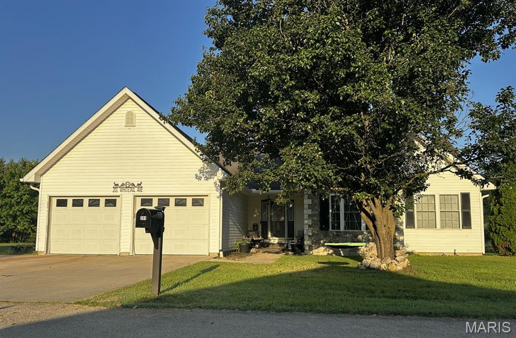 Custom 4-bedroom, 2-bath, 2,256 sq ft home offering spacious living and approximately 0.738 acres, including an additional lot behind the home! The majority of the home, including the custom primary suite, was remodeled in 2022. The primary suite features a large walk-in closet with the washer and dryer conveniently located inside. The kitchen was remodeled in 2025 with new countertops, backsplash, soft-close cabinets, and a spacious 7x4 walk-in pantry. The main living area features vaulted ceilings, luxury vinyl plank flooring, and a fireplace with faux stone surround. The enclosed sunroom/family room features pine walls and a mini-split added in 2025. Faux stone accents the front exterior. Outside, enjoy a white vinyl-fenced backyard, 22x22 garage, and 10x12 shed