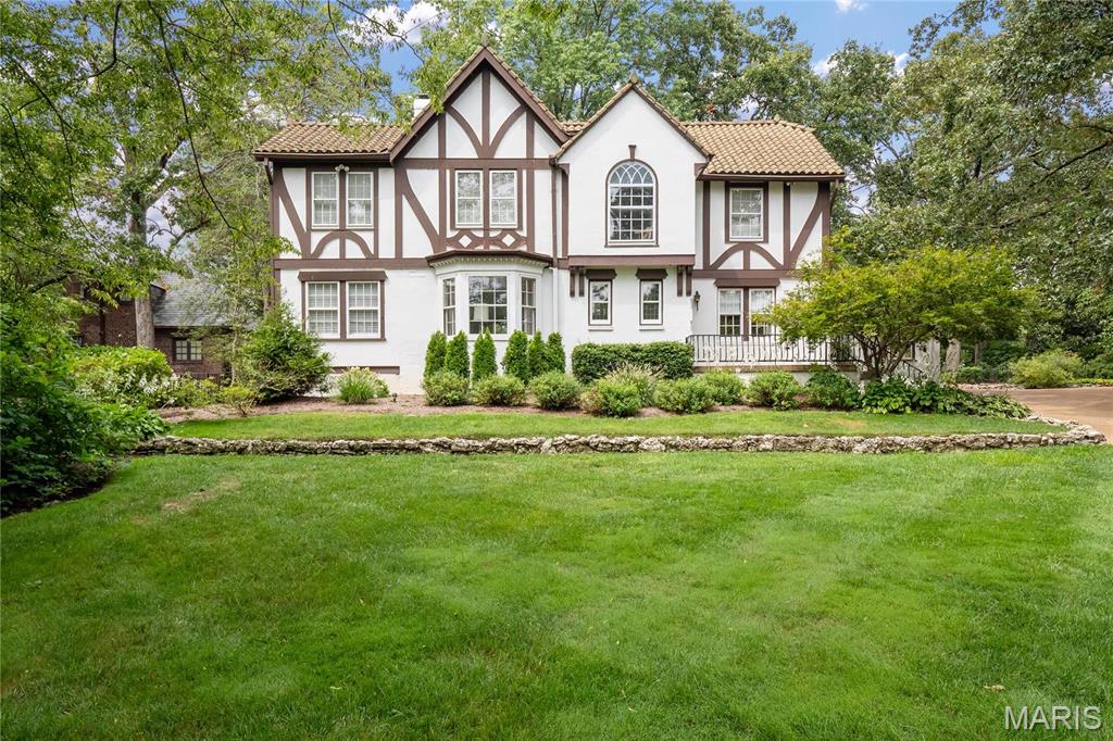 Nestled in the heart of one of Webster Groves’ most desirable neighborhoods, 609 Sherwood Dr. is a classic Tudor-style home offering a perfect blend of history, style, and grace. Timeless features like the grand staircase, arched openings, and beautiful millwork anchor the spacious formal living and dining rooms. Warm hues and vibrant accents create a wonderfully warm home for entertaining. The kitchen features , high-end appliances, and makes an ideal transition to the rear sunroom, where 3 walls of windows flood the space with natural light. It’s the perfect vantage point to enjoy the property’s lush greenery, manicured hedges, and stunning brick pathways. The 2nd floor includes 4 fabulous bedrooms and 3 full baths, with a 5th bedroom located on the 3rd floor. With its architectural beauty and elegant interior, don’t miss the opportunity to see this unparalleled home!