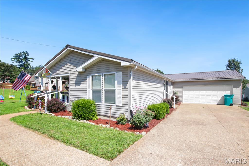 Welcome to this ready to move in home!  This home offers 3 spacious bedrooms and 2 full bathrooms with an open concept living room, dining room and kitchen.  It has a main floor laundry with direct access to the attached 2-car garage.  The metal roof and HVAC system are 5 years old.  Fresh paint throughout the interior.  The spacious primary bedroom with walk in closet has a full bathroom with separate shower and garden tub.  The large second bedroom also offers a walk in closet. The front covered porch and open back deck offer plenty of room to entertain, BBQ, or just sit and relax.  With a low maintenance exterior and yard that is nicely landscaped, this move-in home is ready for you to enjoy!