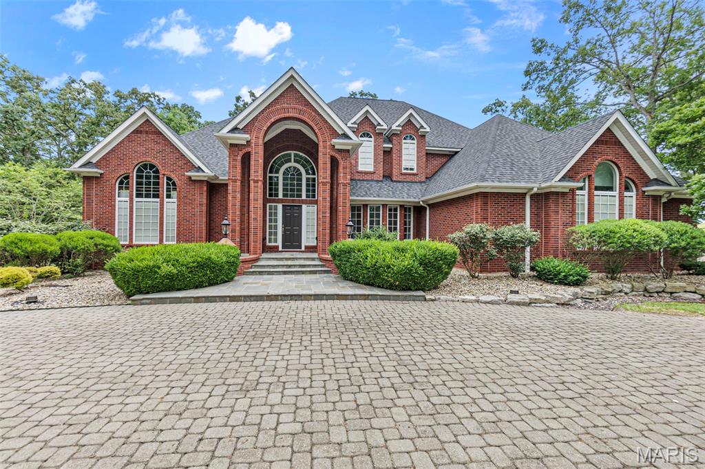 Are you searching for a stately all-Brick estate on 11.43 acres with luxurious amenities and horse facilities? Discover timeless elegance and refined living in this stunning all-brick home, built in 1995, offering an expansive 5,886 square feet of finished living space. Tucked beneath a canopy of mature trees on 11.43 meticulously manicured acres, this 4-bedroom, 5.5-bath estate delivers both grandeur and functionality. Step through the impressive two-story foyer, where a curved staircase and open balcony set the tone for the formal living and dining rooms. The main-level primary suite is a private retreat, complete with a spacious en-suite bath featuring a separate shower, a luxurious soaker tub, and a large walk-in closet with custom organizers. The oversized kitchen is a chef’s dream—equipped with custom cabinetry, quartz countertops, a center island, gas cooktop, double oven, and a butler’s pantry—flowing seamlessly into the sunlit breakfast room and cozy family room with a wood-burning fireplace. Outdoors, enjoy the peace and privacy of mature trees and wide-open spaces. A massive 36' x 103' detached shop includes four overhead doors, a climate-controlled section with kitchenette and half bath, and a separate area with four horse stalls featuring automatic waterers and an adjoining fenced pasture. This is a rare opportunity to own a distinctive home where luxury meets country charm—perfect for entertaining, equestrian pursuits, or simply enjoying peaceful surroundings.