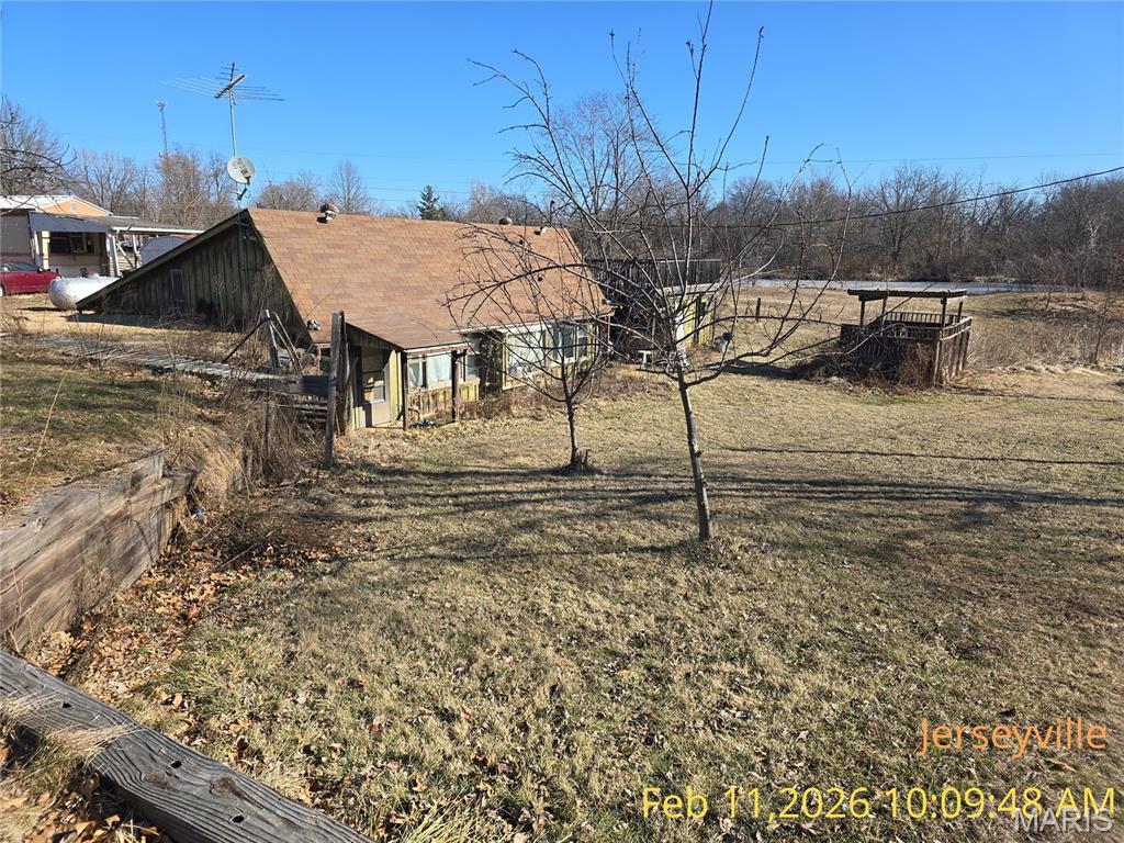 This earth home has 2 bedrooms/2 baths.  There are skylights added to allow for more natural light.  The house has a large lot, fruit trees, and backs up to the lake.  This home is being sold as-is and will require a lot of work.  The unique style of home will make it one of a kind when it is remodeled.  There is an open living/kitchen area.  The primary bedroom has an ensuite and is a good size.  There is a large detached deck area with storage underneath.  Once you visit the property, hear the sounds of nature and capture a vision for a finished project, you will be ready to contact your favorite real estate agent and get a contract submitted!  The home is being sold as-is and no repairs will be done on the property.