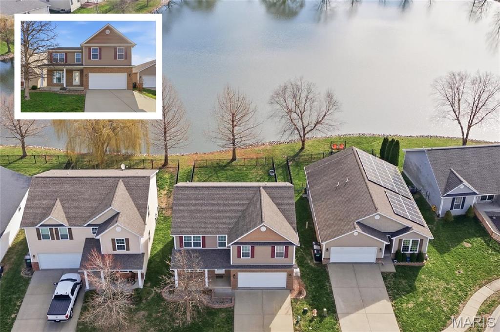 This spacious, lakefront home in Mascoutah offers the perfect blend of comfort and functionality boasting an open-concept layout and a finished basement. Step onto the welcoming covered front porch and into a main level featuring gorgeous hand-scraped hardwood floors throughout.
Just off the entryway, an arched opening leads to a versatile room that would make a perfect dedicated office. The living room features a cozy gas fireplace and flows seamlessly into the eat-in kitchen, complete with a butterfly island, stainless appliances, and walk-in pantry.
Upstairs, you'll find a spacious loft that works perfectly as a second living area or reading nook. The primary suite is a true retreat offering dual walk-in closets and 5 piece en-suite.  Three additional generously sized bedrooms and a full guest bathroom complete the upper level.
The finished lower level provides even more living space with a cozy rec room (currently used as a third living area), a full bathroom and plenty of storage. An egress window is already in place, making it easy to add a fifth bedroom if desired.
Step outside to enjoy the fenced backyard with peaceful lake views. Homes with these views don’t happen often – schedule your appointment today!