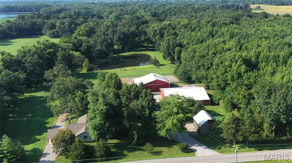 THIS IS A NICE HORSE FARM !!  60 Acre farm in Franklin Co. IL near Thompsonville.  Residence is 1,950 square feet with 3 bedrooms and 2 baths.  Includes newer appliances, nice great room and patio.  Addition and remodel completed in 2000.  Kitchen remodeled in 2021.  Master bath includes electric floor heated ceramic tile.  Partial walkout basement with Geothermal along with a wood burner and water filtration system.  Two car covered parking with storage above.   Horse Barn (Newcomb Constr. 2010) measures 16’ 48X48 with 12’ and 20’ lean to’s for extra storage and shelter.   Four stalls – matted, center drains, outside Dutch doors, interior sliding stall fronts.  20X20 Tack room with half bath, gas fireplace, AC Wall unit.  Hay storage and two 12X12’ sliding doors, one 14X14’ sliding door, and one man door.  2 frost free water hydrants in barn.  66X130 Dressage outdoor arena, heated livestock waterer in main paddock, and 4 pasture areas.  True Built Barn (1994), measures 70X60 with a 20’ lean to and has an interior 40X18 portion concreted for a nice work area.  Two 20X14’ sliding doors accommodates RV storage.  10X10 sliding door, 1 man door, underground power and 2 frost free hydrants in barn.  Roof inspection and all new roof screws 2020.  Older 26X32 Refinished wood barn with loft perfect for extra storage.  The pond is almost a full acre in size.  21 acres in CRP that expires 2030.  Pasture. 12 acres of hay fields in two tracts, balance in woods.  Located only one hour from the Shawnee Horse Trail System.