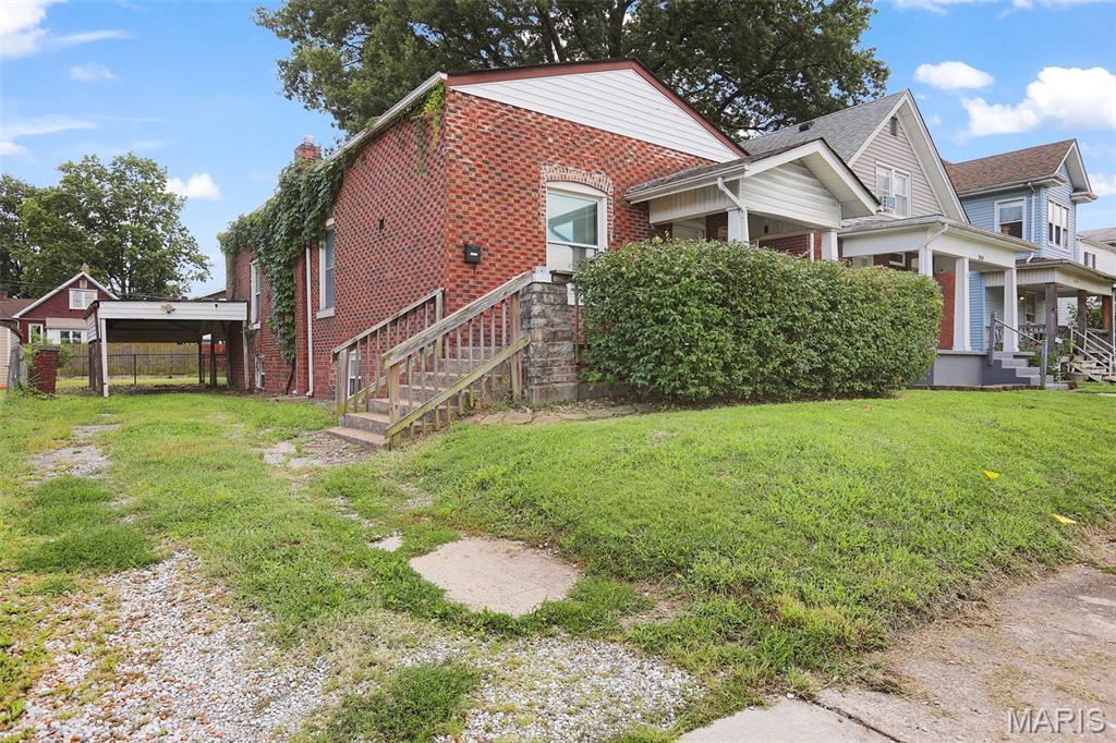 Charming brick bungalow just two blocks from Wilson Park! This 3-bedroom, 1-bathroom home features a front porch entry, spacious living room, and large eat-in kitchen. Enjoy the covered back porch overlooking a large, level, fenced backyard. Full basement offers plenty of extra storage, and a one-car carport adds everyday convenience. Priced for your personal touches — bring your vision and make it your own! Convenient location close to the park, school and amenities. Schedule your showing today!