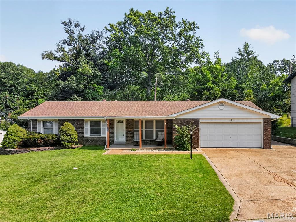 Welcome home to this spacious 3-bedroom, 2-bath ranch in the Cardinal Wood subdivision! Step inside to a freshly painted interior and a versatile floor plan offering plenty of room to spread out. The sunken living room sits just off the entry, while the kitchen connects to both a separate dining room and a comfortable hearth/family room with sliding glass doors leading directly to the backyard and patio. A window above the kitchen sink keeps the backyard in view, adding a little everyday practicality to the heart of the home. Real hardwood flooring runs through the dining room, hallway and bedrooms, with ceramic tile in the bathrooms and easy-care luxury vinyl plank flooring throughout the kitchen and living spaces—no carpet anywhere!

Outside, you'll find a covered front porch, all-brick exterior with an architectural-shingle roof, a fully fenced backyard and an exceptionally functional driveway setup. In addition to the 2-car garage and dedicated storage space, the driveway widens to provide a third parking space alongside the garage and continues around the home to connect directly with the rear patio—great for additional parking and backyard access.

Even better, the entire HVAC system was replaced in July 2026! The refrigerator stays, too. With multiple living areas, hardwood floors, generous parking, a fenced yard and a brand-new HVAC system, this Cardinal Wood home offers a lot of space and flexibility in St. Charles.