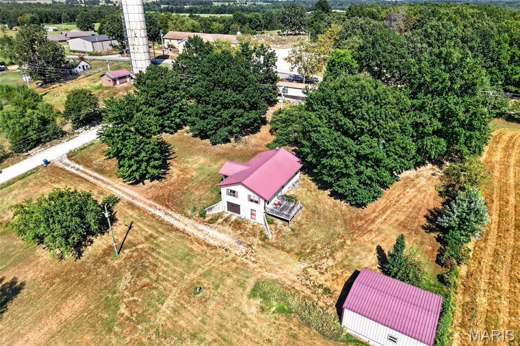 This 3-bedroom, 1.5-bath home sits just outside of town on 0.89 acre, offering a peaceful setting with plenty of space and potential. The home is ready for some updating, giving the next owner an opportunity to make it their own. A two-car garage beneath the home includes a storm shelter and a convenient chairlift providing access to the main level. In addition, the property features a separate 720 sq. ft. shop/garage, perfect for additional vehicles, storage, hobbies, or workspace. With nearly an acre, multiple garage and shop spaces, and a location just outside of town, this property offers plenty of possibilities!