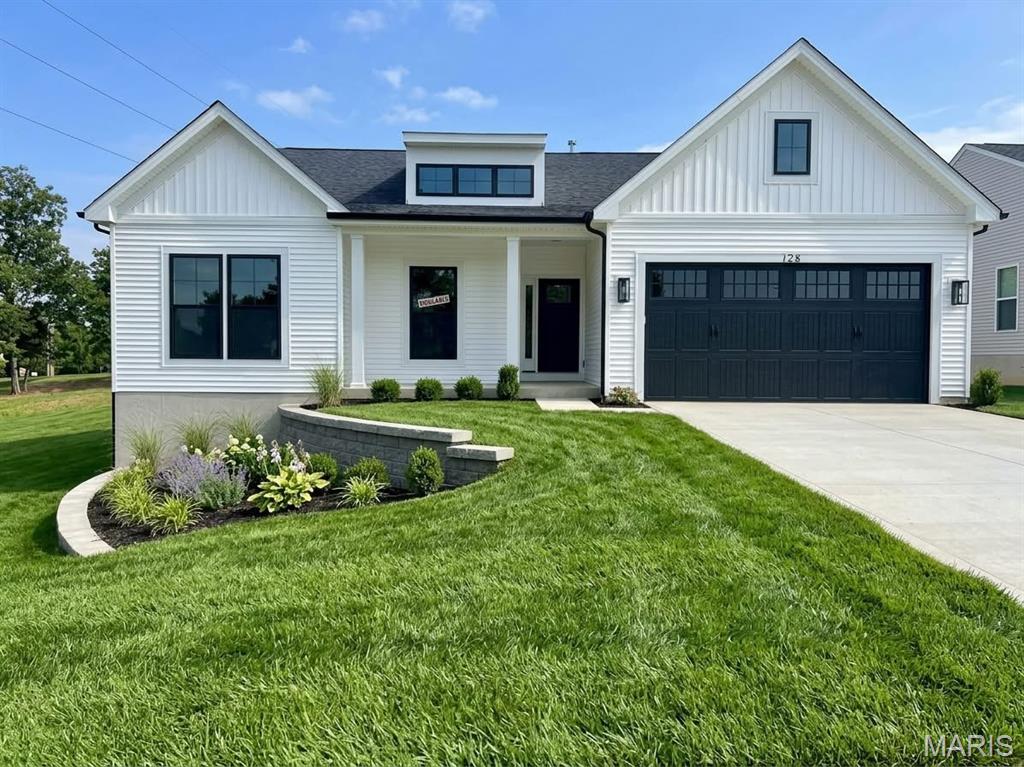 Move-in ready new construction ranch in Kreder Farms, St. Charles. This completed Rockport plan pairs an open layout with modern finishes, anchored by a vaulted great room where an added center window brings in extra natural light. 9-ft ceilings, contemporary stair railings and matte black interior door hardware keep the look clean and consistent throughout.

The kitchen is ready for everyday living and entertaining, with 42" cabinetry, quartz countertops, a stainless steel sink, matte black hardware and fixtures, and a black appliance package (electric range, dishwasher and over-the-range microwave). Laminate flooring runs through the foyer, kitchen, dining room, great room, owner's bath and laundry, with carpet in the bedrooms.

The owner's suite has a private bath with a double-bowl vanity and marble countertop. The walkout basement includes a 3-piece bath rough-in, so there's room to finish and expand later. Outside: white siding with black accents and a 2-car front-entry garage with a 2-ft front extension.
