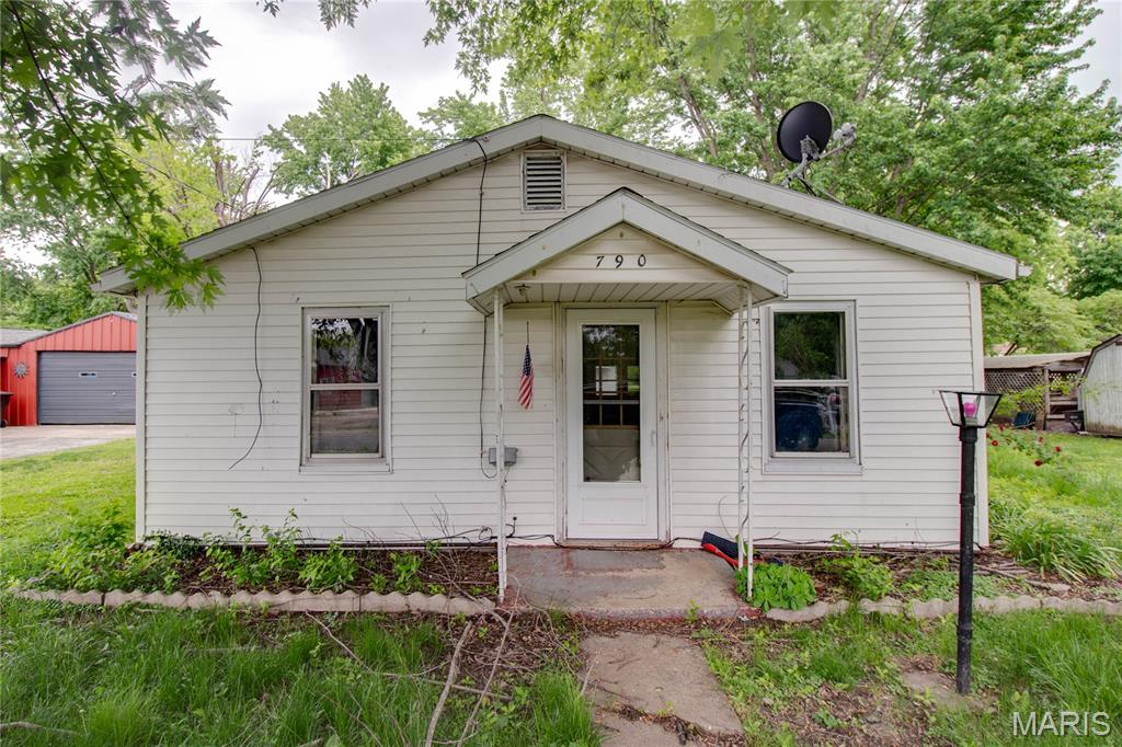 Looking for an affordable home with great potential? This 2 bedroom, 1.5 bathroom home offers a solid structure and is ready for your personal touch. The open concept living and dining area creates a welcoming space for everyday living and entertaining. Spacious kitchen with gas range and refrigerator included. Main floor laundry adds convenience. Enjoy the nice-sized backyard featuring a covered porch and additional storage building for extra space. A great opportunity to make this home your own!