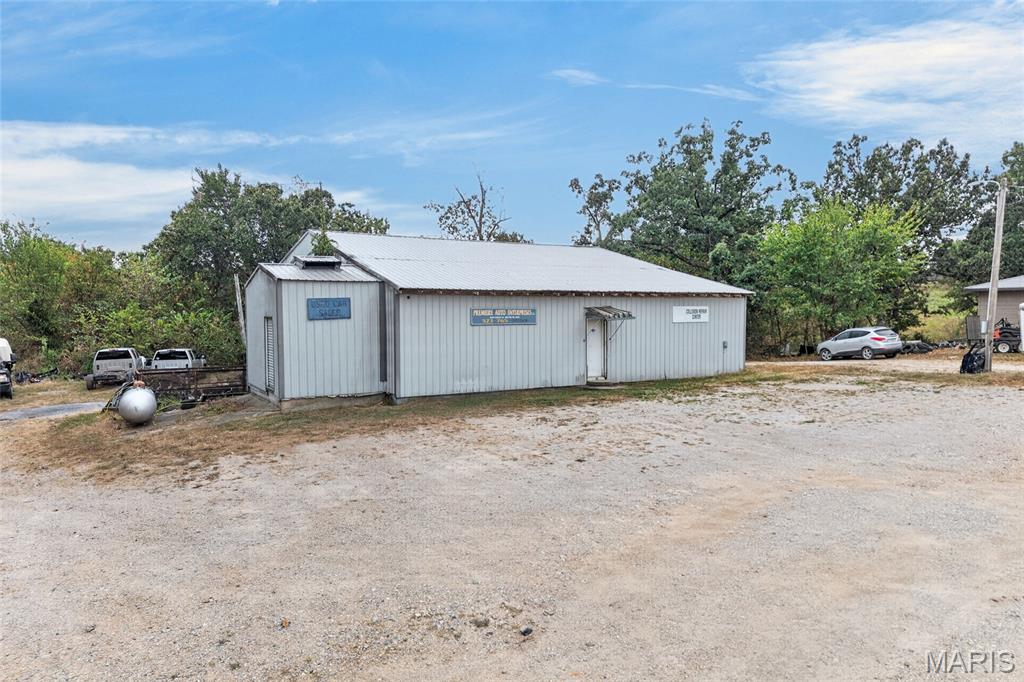 Real Estate only! Currently home to Premier Auto Body, this versatile commercial property offers approximately 4,000 sq. ft. of space with a setup well suited for automotive, body shop, fabrication, service, storage, or a variety of other commercial uses.

The lower level features approximately 2,400 sq. ft. with 14' ceilings, a vehicle lift, large overhead door access, a bathroom, 3-ton mini-split, and dual propane Dayton heaters. The upper level provides approximately 1,600 sq. ft. and includes additional shop space, a paint booth, office area, bathroom, and additional overhead door access. Three 12'x16' overhead doors provide excellent access throughout the building.

Situated on approximately 1.49 acres with convenient access to Richland and the surrounding Central Missouri area. Property is served by city water and electric with a lagoon. Whether you're looking to expand an existing business, open your own shop, or add a versatile commercial property to your portfolio, this one is ready for its next chapter!