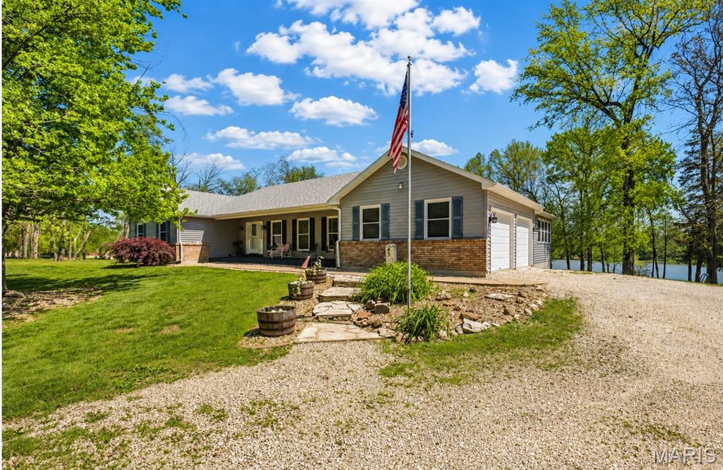 Price Improvement.  Back on the Market at No Fault of Sellers!!!  New Septic tank and Sump Pump Installed.
Lakefront living on 4.3 +/-; acres overlooking a picturesque 15-acre stocked lake! This spacious home offers just under 3,000 sq ft of main floor living, where vaulted ceilings in the family room, kitchen, dining, and primary suite create an open, airy feel filled with natural light. The eat-in kitchen is designed for gathering, featuring a large 4x8 island with overhang, abundant cabinetry, and a generous pantry. The dining area is highlighted by a bay window that frames peaceful lake views, while a see-through fireplace adds warmth and charm between the living room and dining space.
The primary suite is truly a retreat—generously sized with new paint and flooring, a bay window, private access to the deck, and its own see-through fireplace. The ensuite bath includes double sinks, a walk-in shower, water closet, and two walk-in closets. A sunroom wrapped in windows offers a quiet place to relax and take in the water views year-round.
The main floor also includes laundry with a full bath, a butler’s pantry with an updated half bath, and three additional oversized bedrooms (two with vaulted ceilings; fourth currently used as an office), providing flexibility for guests, work, or hobbies.
The walkout lower level is ready for your vision, already featuring a full bath, second rough-in, and framing for an additional bedroom—ideal for creating extra living space, a private suite, or recreation area.
Step outside to the 14x36 deck, perfect for morning coffee or evening unwinding, all set against a scenic lake backdrop. Additional features include an insulated 2-car garage, new roof and skylight, replacement windows and exterior doors, two heat pumps, humidifier system, 400-amp service, and newer hot water heater.
A rare opportunity to enjoy space, privacy, and lakefront living—just minutes from town and located in an area seeing significant growth and infrastructure investment, adding long-term value and appeal. Come experience the setting for yourself.
