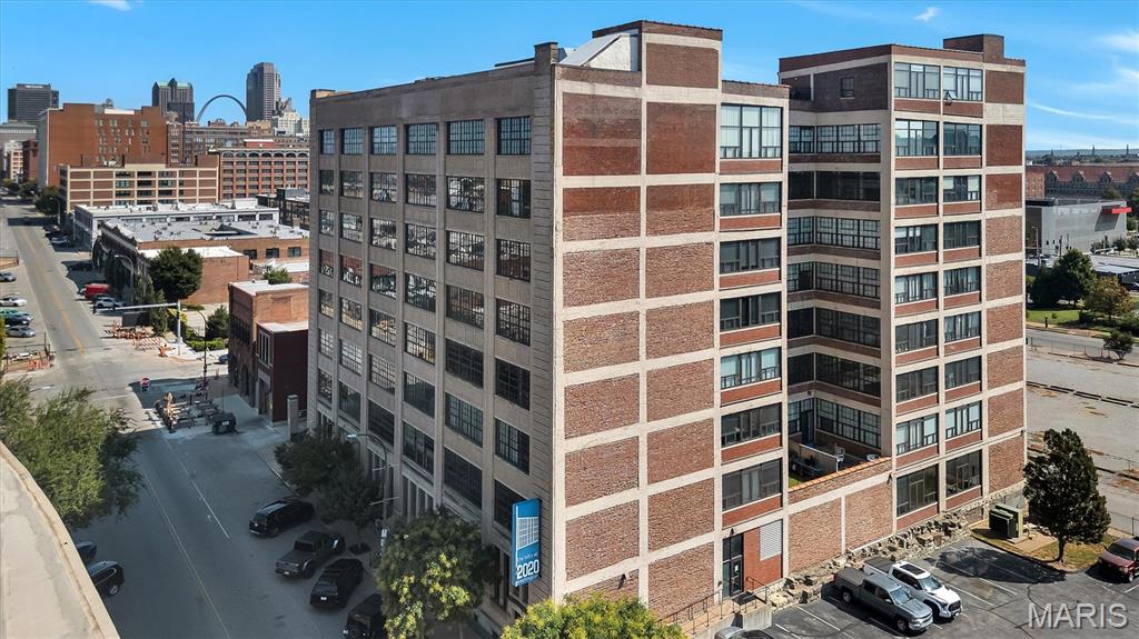 Turn-key loft living in the heart of Downtown. Unit 501 offers 1,007 square feet of open, light-filled space inside a 1920 brick landmark on Washington Avenue. Living and dining flow into a kitchen with stainless appliances and solid surface countertops, plus an oversized walk-in closet — the one thing most lofts don't have. Full-size washer and dryer in unit. Ceramic tile and luxury vinyl throughout, no carpet anywhere. Head upstairs to the rooftop patio for grills, seating and sweeping views of the city skyline — spectacular after dark. Assigned garage parking space #58 in the secured lower level conveys, and the $273 monthly fee covers water, sewer, trash and common areas. Key card entry, elevator, fire sprinklers and building security. Transit at the door, Washington Ave dining and nightlife just outside, minutes to Ballpark Village, the Central West End and both interstates. 2025 taxes $1880. Easy to show.