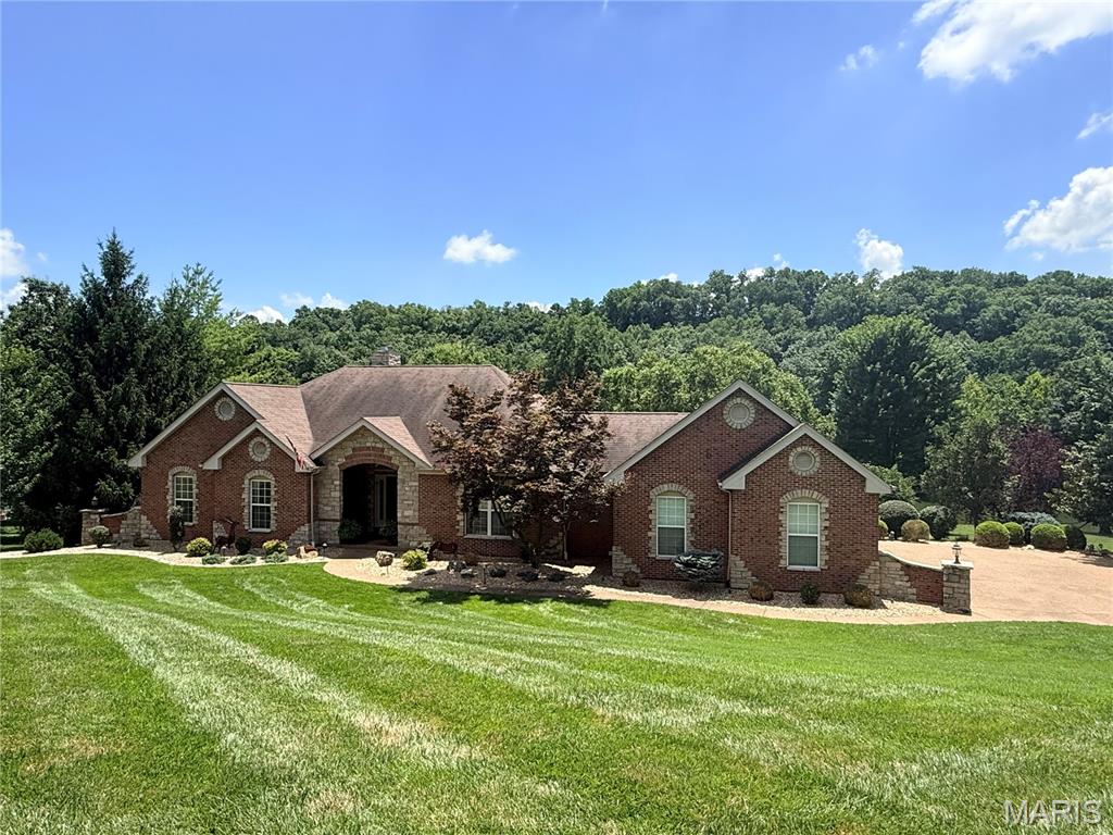 Welcome to luxury living in the heart of Missouri wine country! Nestled on a beautifully landscaped 1.12-acre lakefront lot in sought-after Augusta Shores, this stunning 4-bedroom, 3.5-bath atrium ranch offers nearly 4,800 square feet of thoughtfully designed living space and an incredible resort-style backyard. Step inside to an open, light-filled floor plan featuring soaring 12-foot ceilings, a dramatic wall of windows overlooking the backyard oasis, a cozy wood-burning fireplace, and elegant architectural details—including tray ceilings, crown molding, and recessed lighting. The chef's kitchen is designed to impress with granite countertops, a center island, breakfast bar, tile backsplash, stainless steel appliances, double ovens, 42-inch custom cabinetry, and an adjoining breakfast room surrounded by a beautiful five-bay window. The private primary suite is a true retreat, complete with a shiplap ceiling, crown molding, two custom walk-in closets, a spa-inspired bath with soaking tub, separate shower, dual vanities, and private water closet. French doors lead directly to a secluded deck overlooking the picturesque backyard. The finished walkout lower level is perfect for entertaining or multi-generational living, featuring an expansive family and recreation room with a second fireplace, a full second kitchen and bar, breakfast area, fourth bedroom, walk-in closet, and full bath. Outside, your own private paradise awaits with an in-ground pool, cascading waterfall, putting green, stocked lake, and expansive outdoor living spaces designed for relaxation and entertaining. This home also has a whole house generator for peace of mind and comfortable living  (Duro Max Next Generation Power Max).
Augusta Shores offers an unmatched lifestyle with three stocked lakes, community pool, clubhouse, tennis, pickleball and basketball, a pavilion, hiking trails, and 1GB fiber optic internet included in the HOA. Located directly across from the Katy Trail and Klondike Park and surrounded by the rolling vineyards and award-winning wineries of Augusta, this exceptional home combines luxury, recreation, and breathtaking natural beauty in one unforgettable setting.