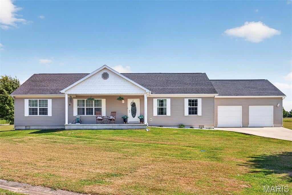 Enjoy spacious, comfortable one-level living in this fabulous 1,840 sq. ft. ranch! Situated on a corner lot, this well-designed home features a desirable split-bedroom floor plan with 3 bedrooms, 2 full baths, main-floor laundry, and a 2-car attached garage. The HUGE kitchen is sure to impress with a large center island, abundant workspace, and a generous dining area perfect for everyday meals or entertaining family and friends. Retreat to the spacious primary suite featuring an amazing private bath with a soaking tub, separate shower, and large walk-in closet. Neutral decor throughout makes this home warm, inviting, and easy to make your own. For added safety and peace of mind, the attached garage includes a professionally installed storm shelter. Enjoy the affordability and relaxed pace of small-town living while still being just minutes from I-70, making your commute and access to shopping, dining, and other amenities quick and convenient. A wonderful combination of space, comfort, location, and value!