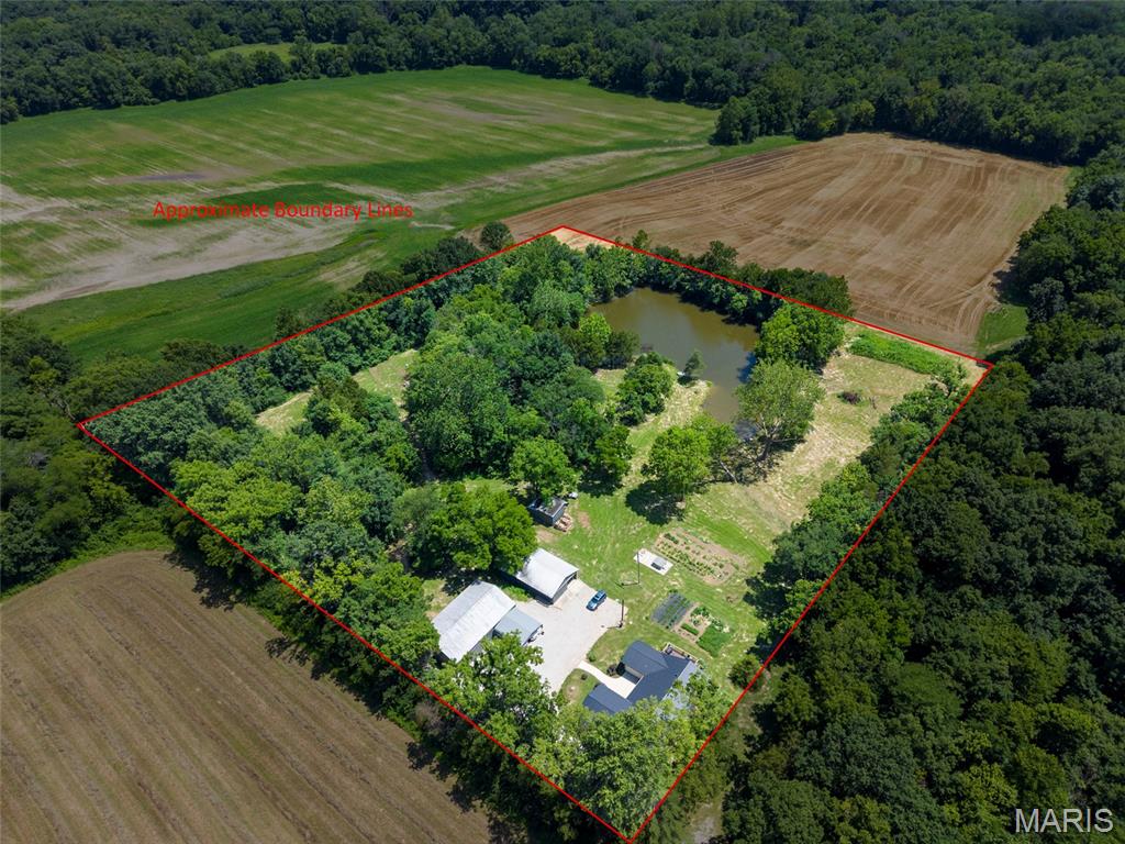 Reimagined just four years ago with a complete top-to-bottom renovation, this extraordinary estate is where timeless elegance meets peaceful country living. Nestled on just under seven picturesque acres, this one-of-a-kind property offers the privacy, beauty, and quality that discerning buyers rarely have the opportunity to own. From the moment you arrive, you'll appreciate the meticulous attention to detail throughout every inch of this remarkable home. The spacious open-concept living area seamlessly connects the stunning kitchen, dining, and family room, creating an inviting atmosphere that's equally perfect for entertaining or everyday living. The showpiece kitchen is a true work of art, featuring exquisite custom soft-close cabinetry handcrafted by Weis Woodworks Inc., luxurious granite countertops, a farmhouse sink, premium SMARTCORE Ultra waterproof flooring, and finishes that perfectly blend modern convenience with timeless farmhouse charm. Offering four generously sized bedrooms and two beautifully appointed full bathrooms, the home is thoughtfully designed with comfort and accessibility in mind, including ADA-compliant features throughout. Step outside and discover your own private paradise. Expansive Trex decking overlooks breathtaking views, while the stocked pond is a dream come true for anglers. Cast a line for black crappie, trophy bluegill, catfish up to 8 pounds, and bass—including a recently caught 7 and a half pound largemouth. A steel dock makes enjoying the water effortless, whether you're fishing at sunrise or relaxing at sunset. Nature lovers will appreciate the abundant wildlife, with deer and turkey frequently roaming the property, creating an ever-changing backdrop of natural beauty in every season. The impressive 56' x 36' insulated pole barn is ready for work, hobbies, or storage, complete with a wood-burning stove that keeps the space warm and comfortable throughout the winter months. A second large outbuilding provides even more versatility for equipment, recreational vehicles, or future projects. Despite its peaceful rural setting, this exceptional property offers modern conveniences including high-speed fiber internet, while remaining only approximately 20 minutes from Edwardsville and just 15 minutes from Staunton schools. Properties of this caliber are exceptionally rare. Combining luxurious finishes, unmatched craftsmanship, incredible recreational opportunities, breathtaking scenery, and an ideal location, this is far more than a home—it's a lifestyle. Opportunities to own a private estate of this quality simply don't come along often, and yes, those are the correct current taxes on the property. This is the experience you've been waiting for, the experience you deserve.