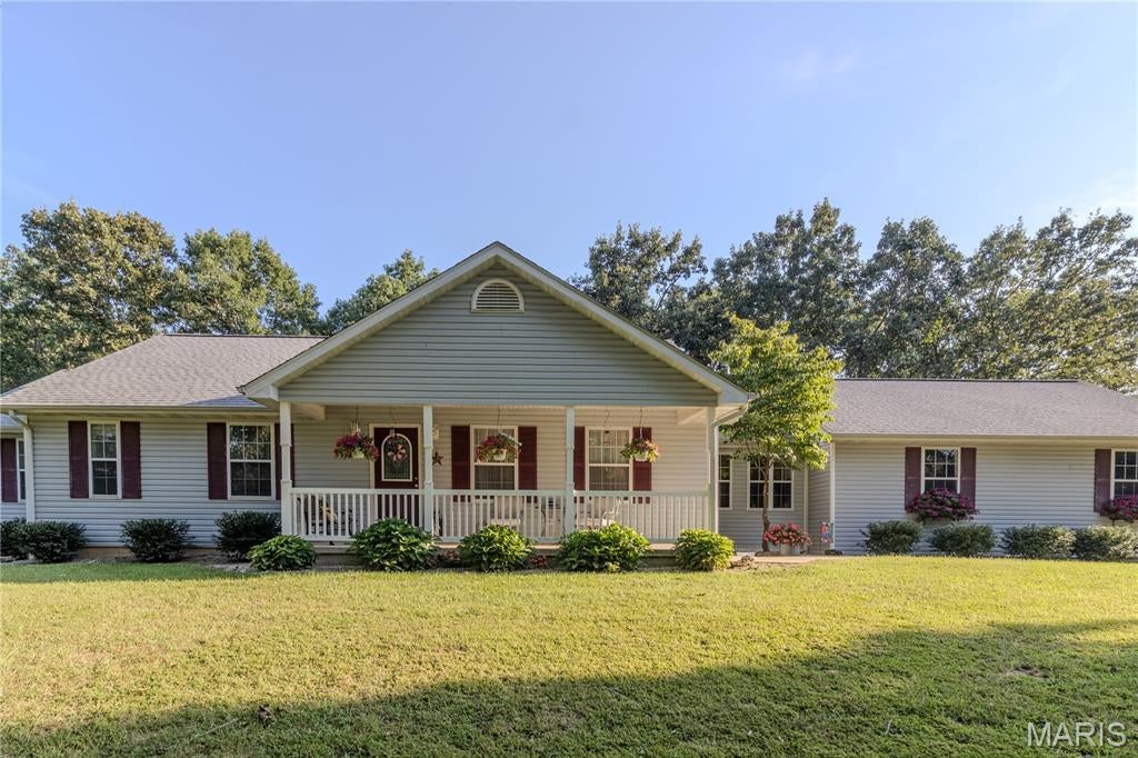 Welcome to your own private slice of paradise! Nestled on 5 beautifully maintained, peaceful acres, this exceptional property offers the perfect blend of immaculate condition, comfortable living, abundant space, and the tranquility of country living. From the moment you arrive, you’ll immediately notice the pride of ownership and meticulous care that has gone into every corner of this remarkable home.
Step inside to discover a bright, spacious, and inviting open-concept main level designed for effortless everyday living and entertaining. The heart of the home is the impressive kitchen, featuring a large center island, gleaming stainless-steel appliances, generous workspace, and an easy flow into the dining and living areas. Just beyond the kitchen, a door leads directly to the concrete patio, complete with a covered pergola—the perfect setting for morning coffee, al fresco dining, summertime gatherings, or relaxing evenings beneath the stars. The main level offers three generously sized bedrooms and two full bathrooms, providing plenty of room for family, guests, or a home office. Convenience is beautifully built into the floor plan with main-level laundry, and the washer and dryer stay with the home, making the move even easier. One of the home's most charming features is the bonus sunroom, a peaceful retreat filled with possibilities. Imagine curling up with a favorite book, enjoying a steaming cup of coffee while watching the seasons change, or creating your own cozy reading nook, hobby space, or relaxation room. The walkout unfinished basement provides tremendous potential for future expansion while currently offering an abundance of valuable storage space. Whether you envision a future recreation room, home gym, workshop, additional living space, or simply need room to store all of life's extras, the possibilities are wide open. An attached two-car garage adds everyday convenience and functionality and has been fully insulated and finished, creating a clean, comfortable, versatile space that goes far beyond basic parking. Outside, the property truly shines. The expansive 5-level acres provide a serene and private setting surrounded by established landscaping and thoughtful outdoor features. Beautiful flower beds, mature landscaping, charming flower window boxes, and a dedicated garden area add color, character, and timeless curb appeal. The covered front porch is an especially inviting spot to slow down and enjoy the peaceful surroundings—a perfect place to sip your morning coffee or unwind at the end of the day. And then there’s the huge shop/garage, offering an incredible amount of space for vehicles, equipment, hobbies, storage, or recreational toys. With two large bays, including one bay spacious enough to accommodate a camper, this property is exceptionally well suited for those who need room to work, create, store, and play. From the immaculate interior to the beautifully cared-for grounds, this property has been lovingly maintained and is pristine, exceptionally clean, and truly move-in ready. The combination of a spacious home, functional layout, finished attached garage, walkout basement, expansive acreage, garden and landscaping, and an enormous multi-bay shop creates a rare opportunity to enjoy both comfort and versatility in one incredible setting. If you’ve been dreaming of a property where there’s room to breathe and space for it all, this one deserves a closer look! NOTE: This home has a St James address, but is located in Crawford County and in Cuba School District.