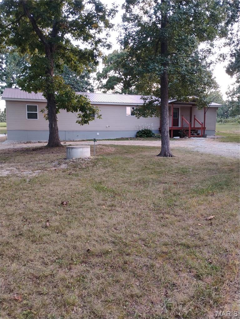 Looking for an affordable place in the country, with a few acres, that sits back from the road and is only a few miles from town?  Here you go!!  Park-like setting has a 3-acre (more/less) lot, with many large trees, including oaks, several hickory nuts and a smaller Magnolia and Willow tree.  Build your dream house or move into this beautifully updated Manufactured home that's had 2 additions added, which included a family room, with a vaulted ceiling, and a dreamy, 10x10 (approx.) walk-in closet off the primary bedroom.  There's also a full bathroom off the primary bedroom.  Other bedroom has a window, but no closet; buyer could add a chifforobe or make it an office.  Updates over the past few years included a metal roof, plumbing, electrical, windows, paint, Amana Range, Ring doorbell, vinyl siding, sheetrock, subfloor and flooring, stylish bathroom sinks and more!  Some window, door and baseboard trim still needed; buyer can purchase that to suit their own taste.  Ask agent about credit being offered to buyer, by Seller.  Just down the road from Towell Lake, at Little Prairie Conservation Area, with public fishing, between Rolla and St. James!!!  Showings by appointment only, please.  This in NOT for rent; for sale only!