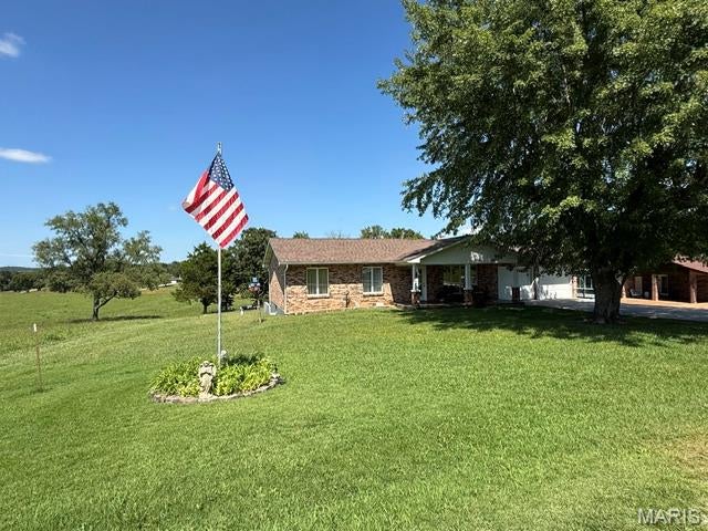 Welcome home to this lovely property located just outside the Potosi city limits, offering the perfect blend of convenience and a little extra room to breathe! A beautiful mature shade tree welcomes you to this charming brick home and enjoy the spacious stamped front porch, while the spacious driveway and two-car garage provide plenty of parking.  Inside, you'll find warm and comfortable living spaces, a bright kitchen with abundant cabinetry and counter space, and a dining area highlighted by a beautiful brick fireplace, then walk out onto the bright sunroom with window AC to keep it cool! The inviting living room offers plenty of space to relax. 
Step outside and enjoy the spacious yard, including a fenced area perfect for pets, play or outdoor entertaining. With its peaceful setting, mature trees and convenient location just minutes from Potosi, this home offers the country feel so many buyers are looking for without being far from town.  In the backyard was a large storage unit, you could easily add another one giving loads of room for storage or wrkshop. 
**Comfortable, inviting and ready for its next chapter—come see what this Potosi-area home has to offer!**