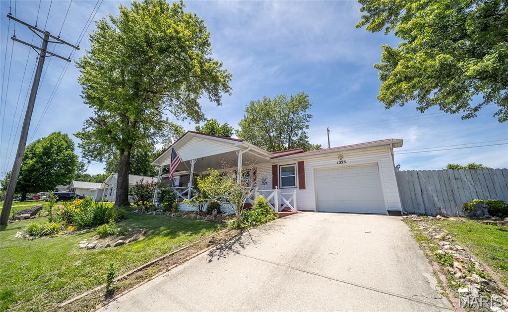 *NEW LISTING | 1525 McCutchen Dr, Rolla, MO 65401* 
Welcome home to this beautifully maintained 3-bedroom, 2-bath residence where comfort, character, and peaceful outdoor living come together in perfect harmony. From the moment you arrive, you'll be captivated by the lush landscaping, vibrant gardens, and inviting covered front porch that create exceptional curb appeal and a warm welcome. Step inside to discover a thoughtfully designed floor plan featuring a spacious foyer and elegant glass French doors that provide the flexibility to create intimate spaces or an open flow for entertaining. The heart of the home is the stunning updated kitchen, offering an abundance of cabinetry, generous counter space, a pantry, and an oversized island with bar seating—making it the perfect gathering place for family and friends. Just beyond, the spacious dining area is filled with natural light and overlooks the picturesque backyard. Outside, you'll find a true backyard oasis. Relax to the soothing sounds of a working waterfall stream while enjoying mature landscaping, colorful blooms, and peaceful garden spaces that have been loved. A greenhouse provides the perfect opportunity to continue growing your own flowers, vegetables, or favorite plants year-round. There is also a red shed for storage. ALSO INCLUDED-is a large Amish-built outbuilding with electricity, heating, and cooling! Use it for storage, a workshop, hobby room, home office, or as a comfortable spot for the kid who swears they're moving out next month!! The primary suite offers a beautifully updated walk-in shower, while handicap-accessible features throughout the home provide added convenience and functionality. A one-car garage with a dedicated workshop area offers additional space for hobbies and storage. If you've been searching an affordable 3 bed 2 bath home in Rolla that has been handled with care, this could be the one for you! Schedule your private showing today and experience all it has to offer!