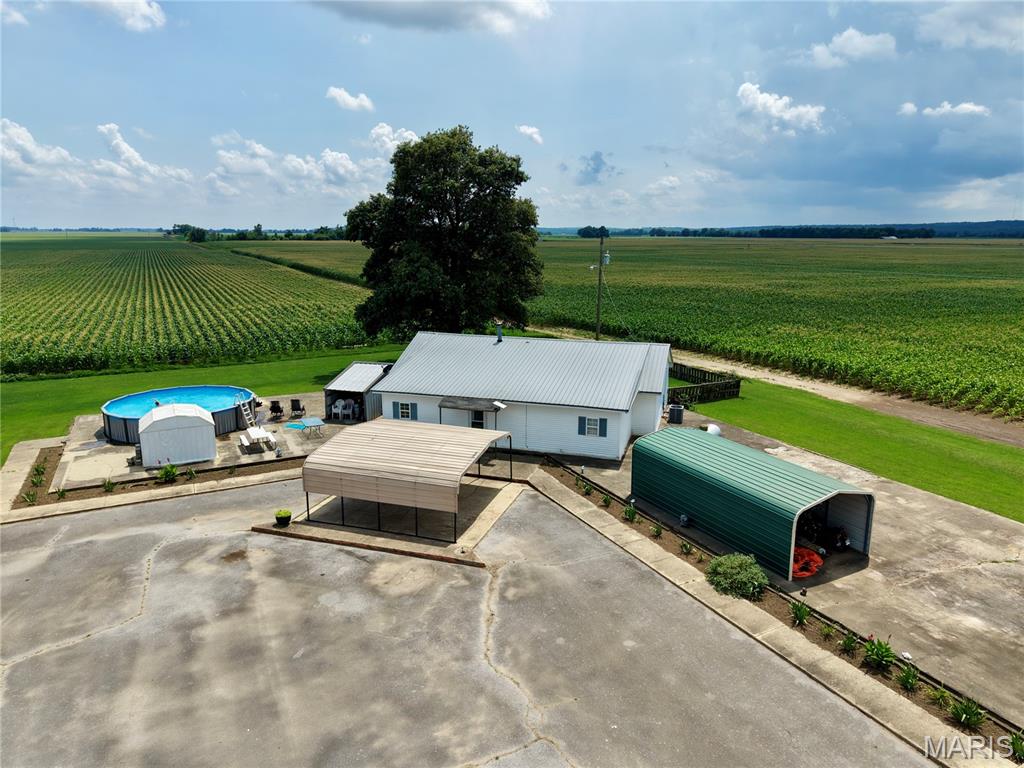 Welcome to 20754 County Road 104 in Malden, Missouri! This well-maintained 4-bedroom, 2-bath home offers plenty of space both inside and out. Recent updates include new carpet and vinyl flooring, giving the home a fresh and inviting feel. The spacious primary suite features a large walk-in closet with a conveniently located laundry area. Both bathrooms offer ample storage, providing plenty of room for linens, toiletries, and everyday essentials.

Outside, you'll find everything you need for comfortable country living, including two carports - one large enough for two vehicles and another ideal for storing a boat, lawn equipment, or recreational gear. Enjoy summer days in the above-ground pool situated on a large concrete pad, along with several utility buildings that provide additional storage space.

The fenced backyard and screened-in back porch create the perfect setting to relax and take in the beautiful views of Crowley's Ridge. With its spacious layout, numerous amenities, and thoughtful updates throughout, this property is ready to welcome you home.