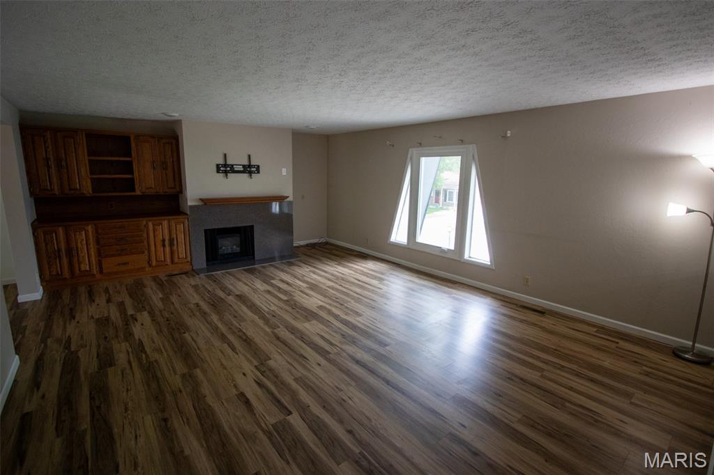 This is truly the kind of home that makes an impression the moment you walk through the door! If space is what you’ve been searching for, this one delivers in every direction. Enjoy oversized rooms throughout, starting with the large living room featuring custom built-in cabinets and an electric fireplace perfect for relaxing or entertaining. The spacious dining room flows directly into the kitchen where you’ll find tons of cabinet space, a center island, pantry, and even a built-in desk area. Sliding glass doors lead out to a large deck overlooking the backyard.

The primary suite is truly something special with an open bathroom layout, private deck access off the bathroom, and closet space that feels more like an additional bedroom! Need even more storage? The bathroom also offers not one, but TWO additional closets.

Head downstairs to the lower level where you’ll find a massive bedroom, huge family room, and game room complete with a wet bar — giving this home endless possibilities for entertaining, relaxing, or multi-generational living.

Outside, the home sits on a double lot with a partially fenced yard and plenty of parking space for guests. Zoned HVAC systems.  Additional updates include a newer roof, and new windows.

Included parcel numbers: 02-2-18-29-13-302-015 and 02-2-18-29-13-302-014.

Homes with this much space, storage, and functionality do not come around often. Schedule your private tour today!