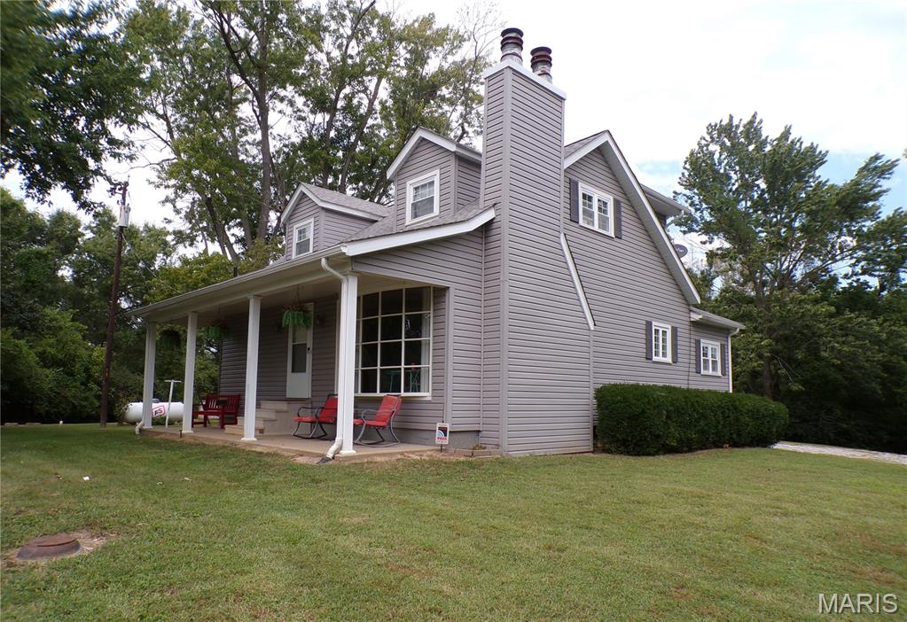 If you have been looking for a home that is in town but feels like you are living in the country, this 3 Bedroom 2 Bath home may be just for you. You may have found your dream with this home that has 1.27 acres and is less than 2 miles from town. It includes a wonderful 24 X 20 extra deep with 9 ft doors garage/out-building. If you want to live with great neighbors but not feel like you are living right on top of them, you may have found just what you want, especially if you have been looking for a place to have a few chickens. You will be able to entertain family and friends with a front covered porch, back covered porch with swing, side yard with above-ground pool, a concrete patio and your very own pad for a camper-complete with electric and water hook up. There is a cleared piece of ground with the parcel, as well as some parts with trees. Is it perfect, No...Is it perfectly wonderful, YES! Make time to come and see this property soon.