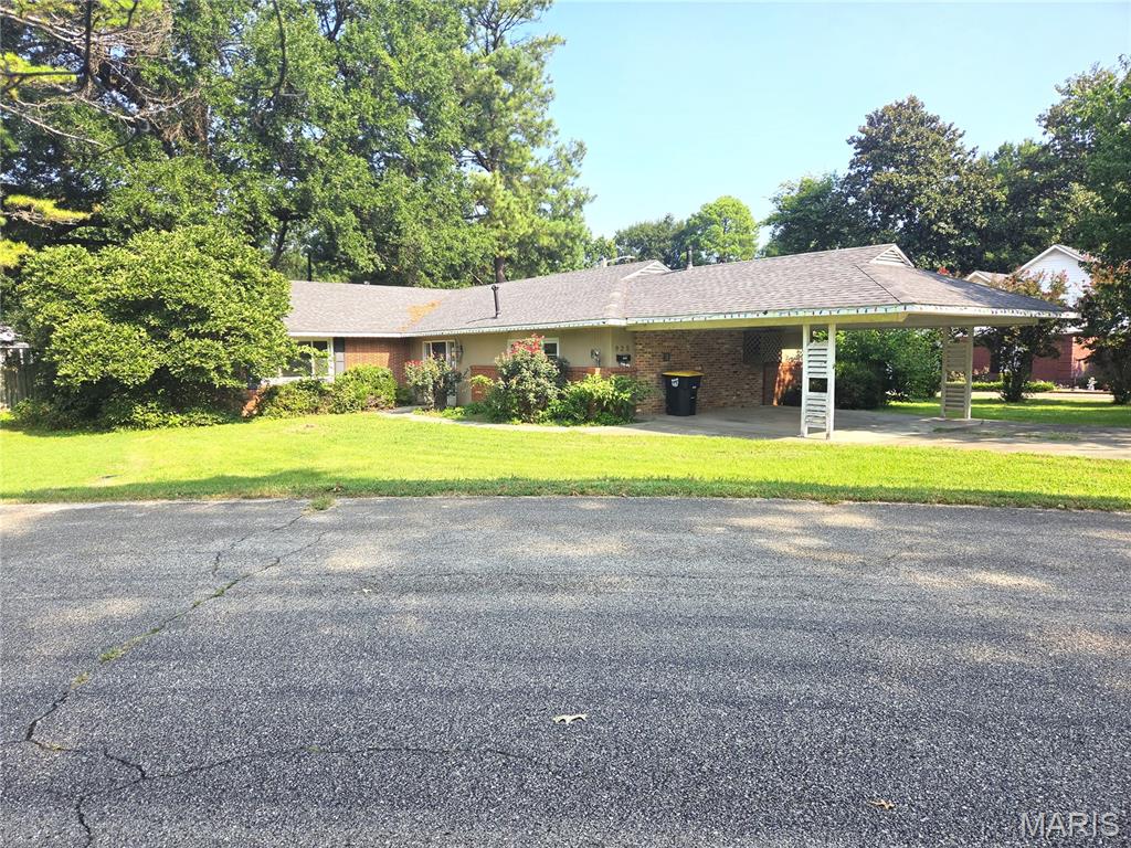 Don't miss out on the chance to invest in your next purchase with this property - bring your tools and innovation! This 3-bedroom 2-bath brick house is located in Baker Addition, allowing for easy access to the North Bypass/Homecrest Street, and a short distance to the Town Square.  Offering 2 large living areas, both with gas log fireplaces and large picture windows - There's even a wet bar off of one of them! The best part of this home is hidden back in your future privacy fenced back yard, with a completely covered deck with built in flower box, and the makings of an outdoor shower with water heater included. The back yard offers lots of shade, privacy, and additional storage in the shed. Cash or conventional only, sold "AS IS".