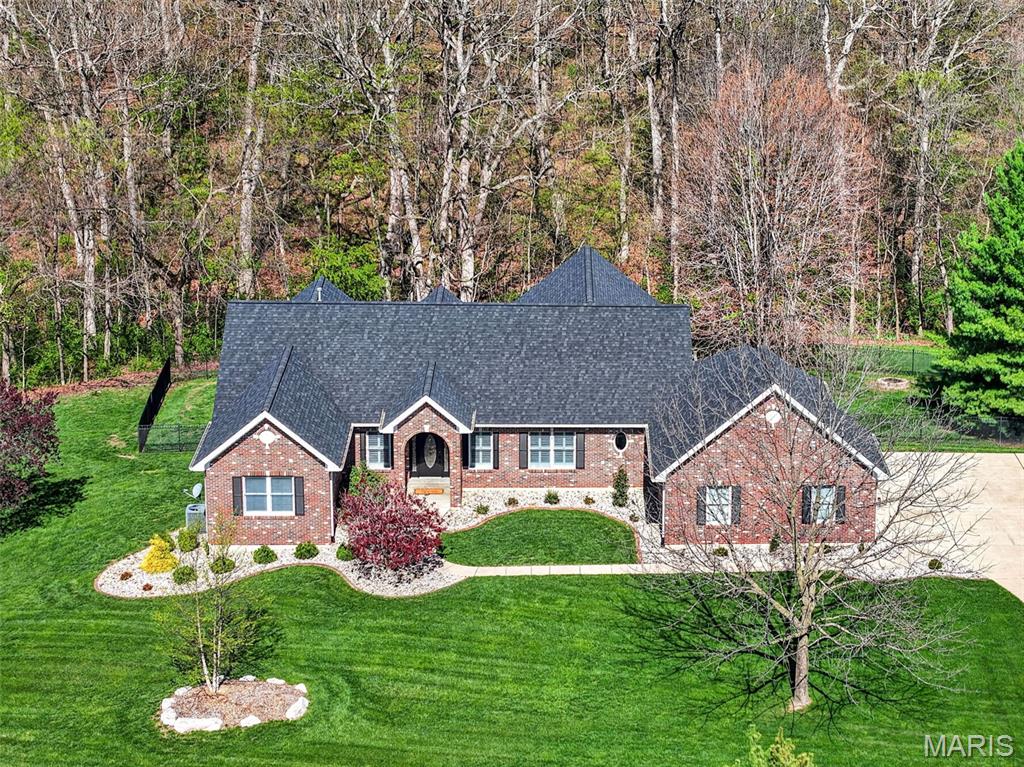 Situated on a picturesque 3-acre lot, this extensively remodeled atrium ranch offers the perfect balance of open green space, fenced yard areas, and mature trees that provide exceptional privacy and breathtaking views year-round.

Completely renovated in 2018, the home showcases quality finishes throughout, including engineered hardwood flooring, a newer roof, and an open floor plan designed for modern living. The stunning four-seasons room is a true highlight, offering panoramic views of the wooded backdrop and abundant wildlife, creating the perfect space to enjoy every season.

The kitchen is designed for both everyday living and entertaining, featuring an induction range, granite countertops, and seamless flow into the main living areas. Convenient main-floor laundry adds to the home's functionality. Every bedroom features its own private en suite bathroom, providing comfort and privacy for family and guests alike.

The luxurious primary suite feels like a private retreat, complete with a beautifully remodeled spa-inspired bathroom designed with both elegance and comfort in mind.

The walkout atrium lower level is flooded with natural light and offers incredible flexibility with a spacious second primary suite, full bathroom, office or sleeping area, and the large family room and recreation room feature beautiful coffered ceilings. Tucked beneath the staircase is a charming built-in playroom that adds character and creativity to the space.

From the stunning views and thoughtfully designed living spaces to the highly desirable Summit Estates location, this exceptional property offers the privacy of country living with the convenience of nearby shopping, dining, and top-rated Fort Zumwalt schools. This is a rare opportunity to own a truly move-in-ready home in one of St. Charles County's premier neighborhoods.