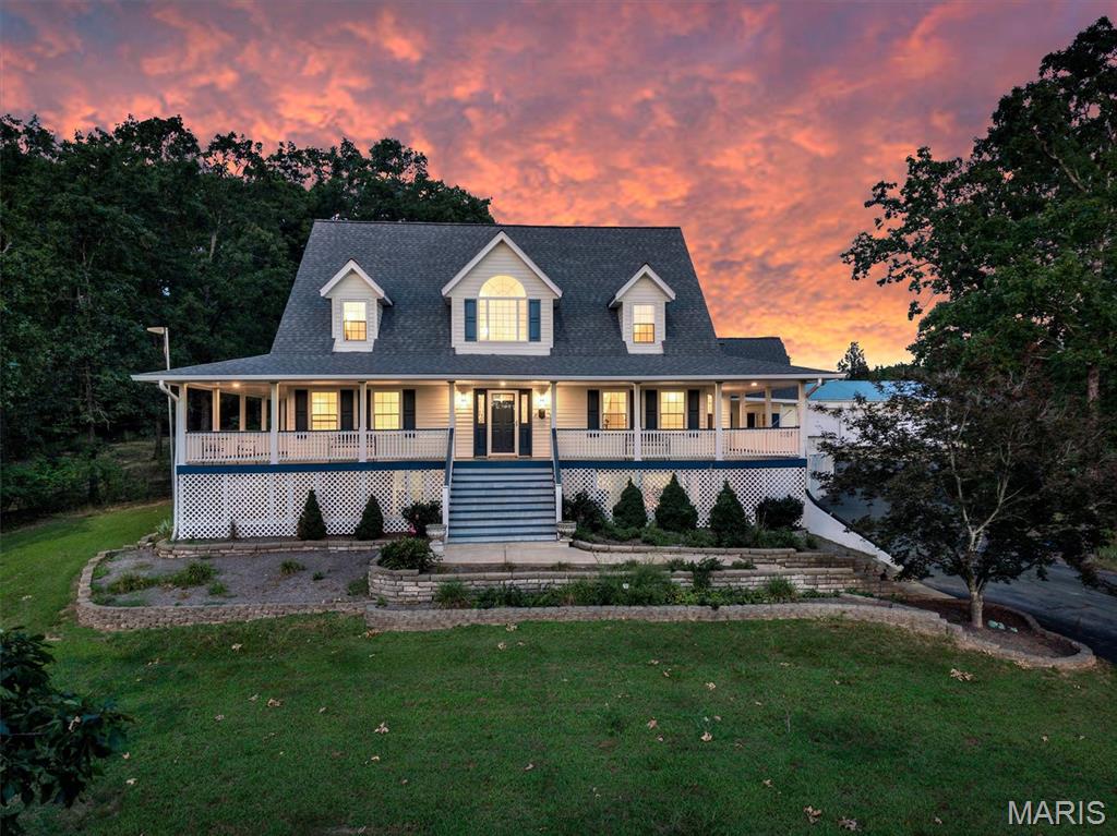 Escape to your own private country retreat on 5.73 breathtaking acres! This beautifully maintained 3-bedroom, 3.5-bath home offers approximately 2,800 square feet of living space, two stocked ponds, incredible outbuildings, and the perfect blend of comfort, privacy, and functionality.

A welcoming wraparound porch invites you to relax and take in the peaceful surroundings before stepping inside to an updated kitchen remodeled in 2016, spacious living areas, newer flooring, and a beautifully renovated primary suite. The spacious primary bedroom features an updated ensuite bath complete with double vanities, a soaking tub, tile flooring, and a separate shower. Main floor laundry adds everyday convenience, with the washer and dryer included.

The finished walkout lower level offers exceptional additional living space, including a large recreation area with built-in cabinetry, a full bath, a dedicated beauty salon area with classic black-and-white tile flooring, and abundant storage. The storage room includes a deep freezer, while the gun safe is available for purchase separately.

Car enthusiasts, hobbyists, and those needing extra workspace will appreciate the attached two-car garage, complete with a 11' x 27' finished bonus room featuring carpeting, a space heater, and a window air conditioner—ideal for a workshop, craft room, game room, or home office. (Stuffed animals in this room are excluded.)

Step outside to experience everything this incredible property has to offer. Enjoy fishing in your own two stocked ponds, relaxing on the wraparound porch, or taking advantage of the impressive 1,200-square-foot pole barn and additional garden shed, providing endless opportunities for storage, equipment, hobbies, or entertaining.

Additional updates include:

* Roof (2017)
* HVAC (2017)
* Windows (2010)
* Water softener (2018)
* Kitchen & family room remodel (2016)
* Primary bath remodel (2018)
* Oven, range & microwave (2016)
* Washer & dryer (2019)
* Driveway paved (approximately 2005)
* Alarm system
* 89-gallon water heater

Located just minutes from De Soto, this one-of-a-kind property offers the rare opportunity to enjoy peaceful country living with modern updates, exceptional amenities, and room to spread out. Whether you're entertaining, fishing, gardening, working on projects, or simply enjoying the view, this move-in-ready estate truly has it all.