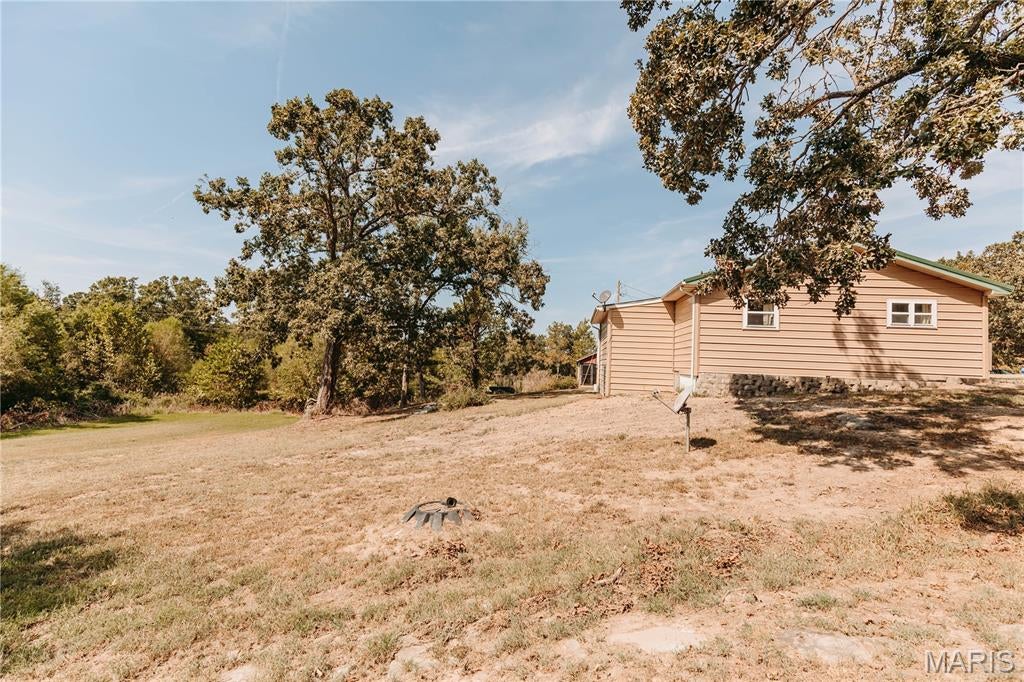 Looking for acreage, privacy, and possibilities? This 2-bedroom home sits on 10+/- acres in the Iberia School District and offers a setting well suited for a primary residence, weekend retreat, rental, or hunting property. Outdoors, you'll find a 1.5+/- acre pond, established food plot with additional areas offering potential for more, a storage shed, and plenty of room to enjoy the land. A circle drive leads you home, all while being approximately 1.4 miles from the highway, offering a balance of rural living and convenient access. Inside, the home features LVP flooring, wood trim, a recently updated bathroom, and a primary bedroom with a walk-in closet. Additional features include a metal roof, fiber internet availability, recently updated well pump, and a back deck overlooking the surrounding acreage. Whether you're searching for a place to call home, an investment or rental property, recreational acreage, or your own hunting retreat, this property brings together 10+/- acres, a pond, food plot, metal roof, fiber internet, and room to make it your own. Come explore the possibilities!